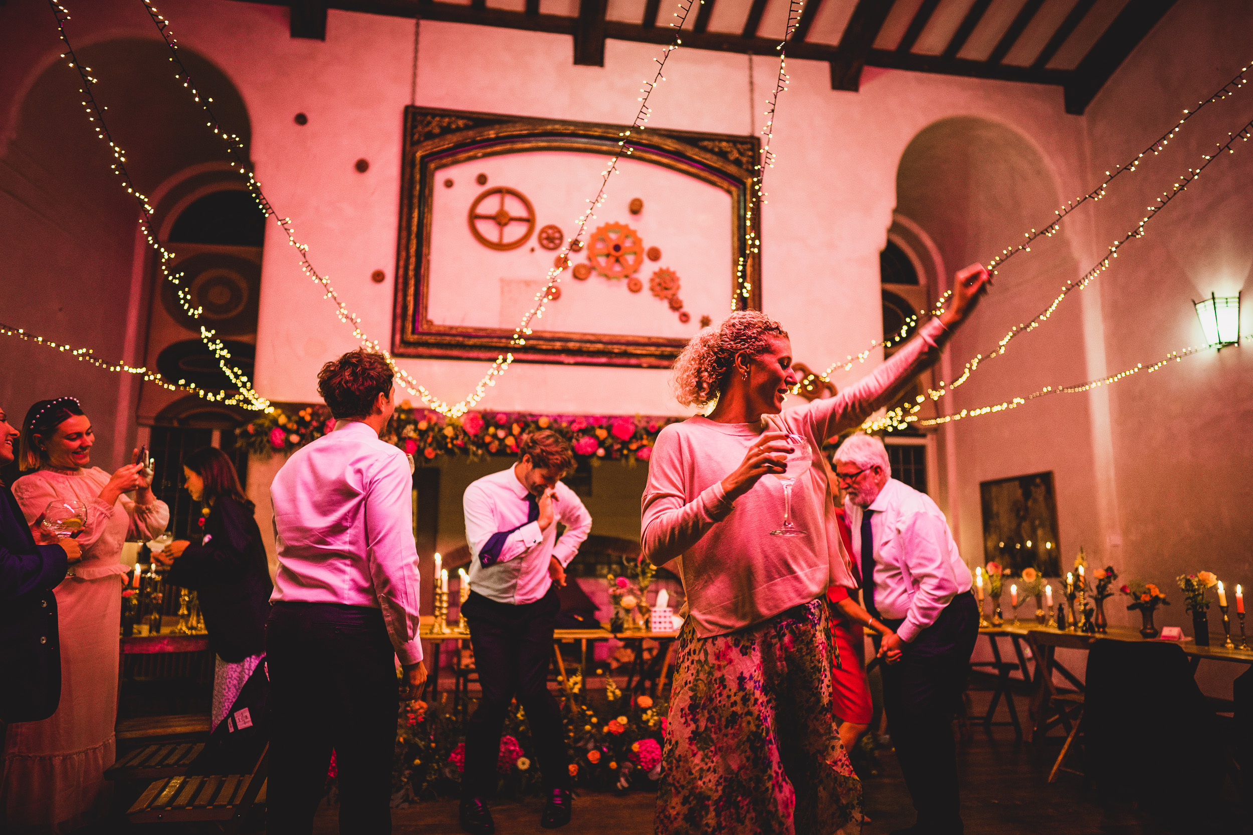 A group of people dancing at a wedding reception, capturing the joyful moments of the bride and groom.