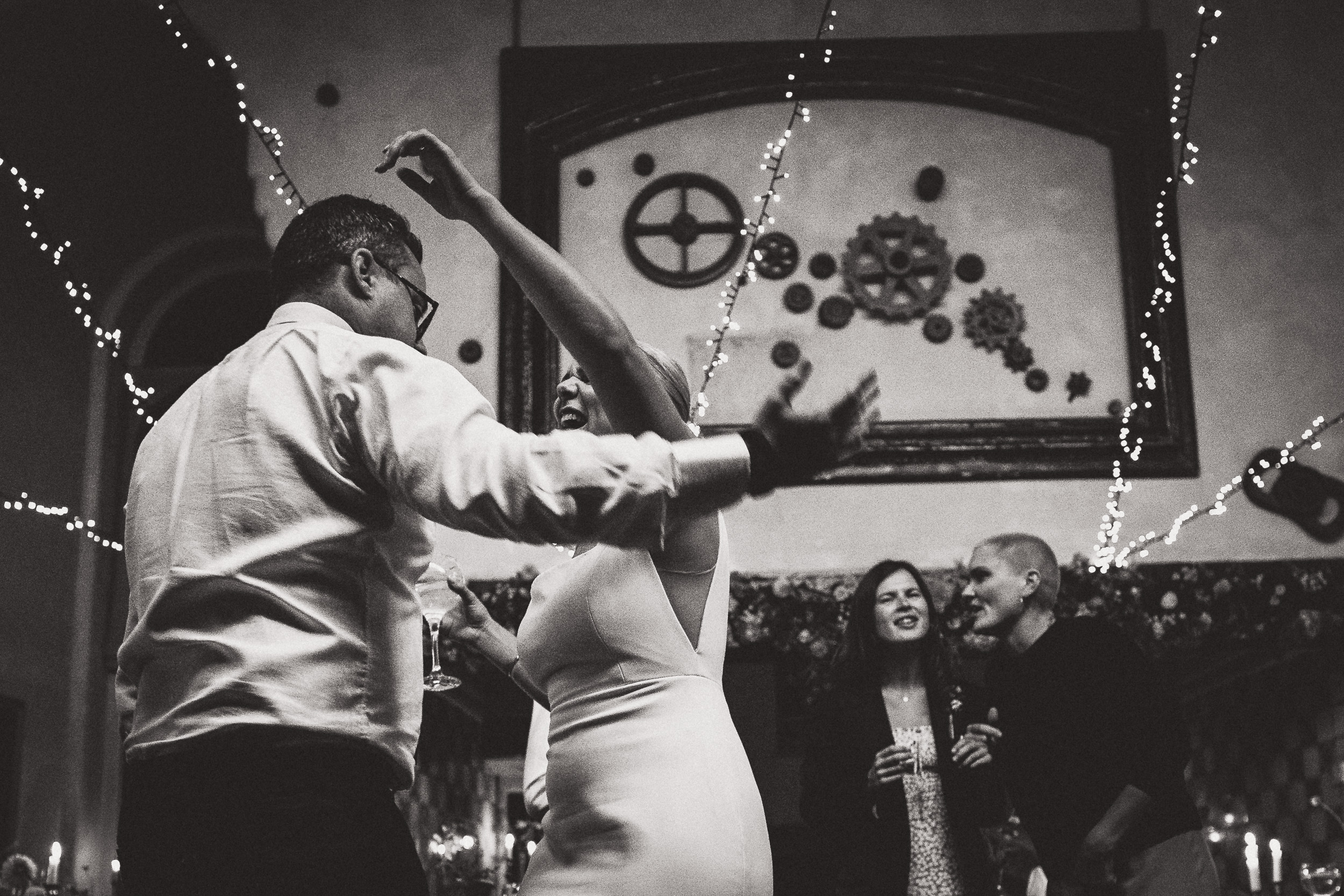 A captivating wedding photo of the bride and groom dancing at the reception.