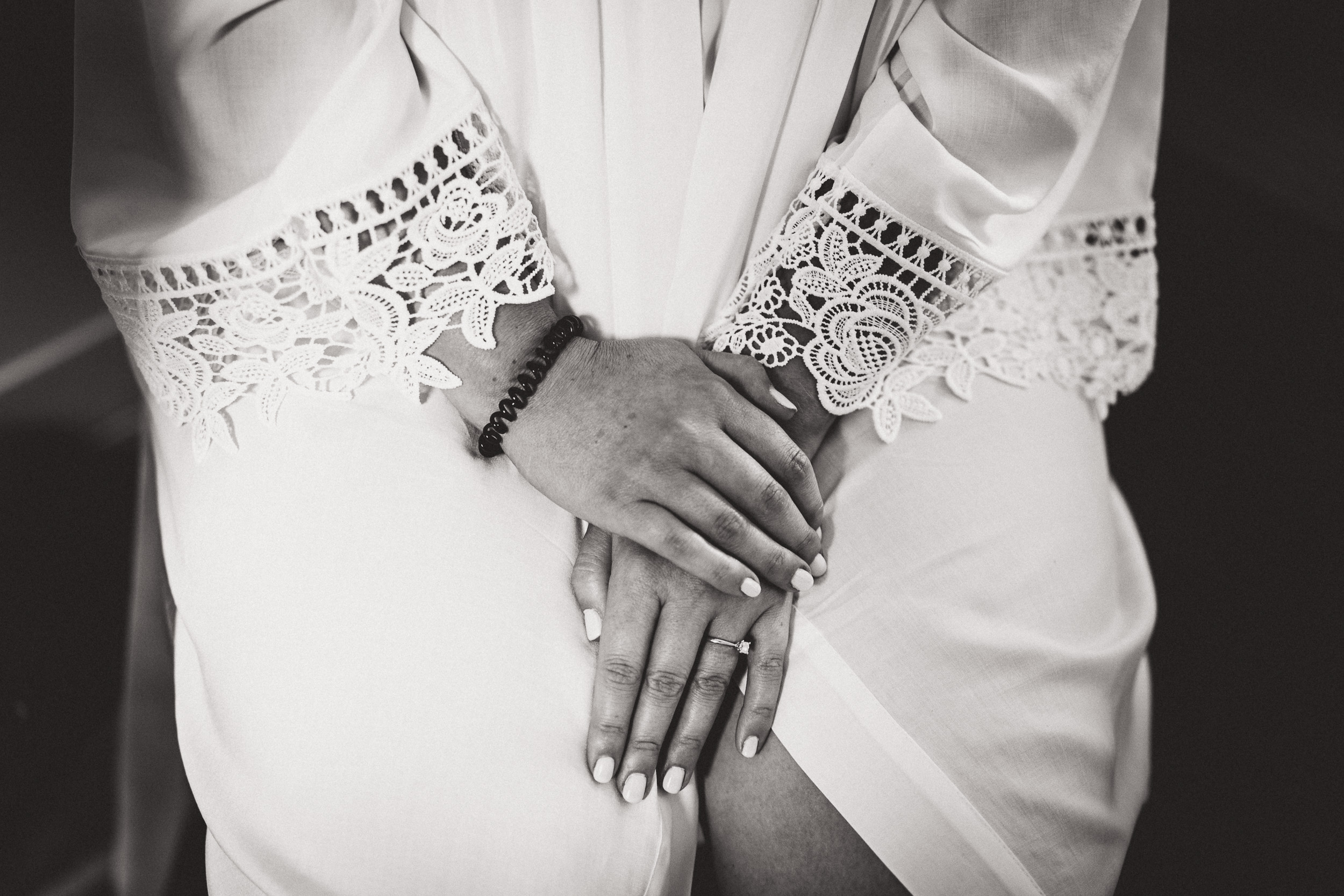 A black and white wedding photo featuring a bride in a white dress.