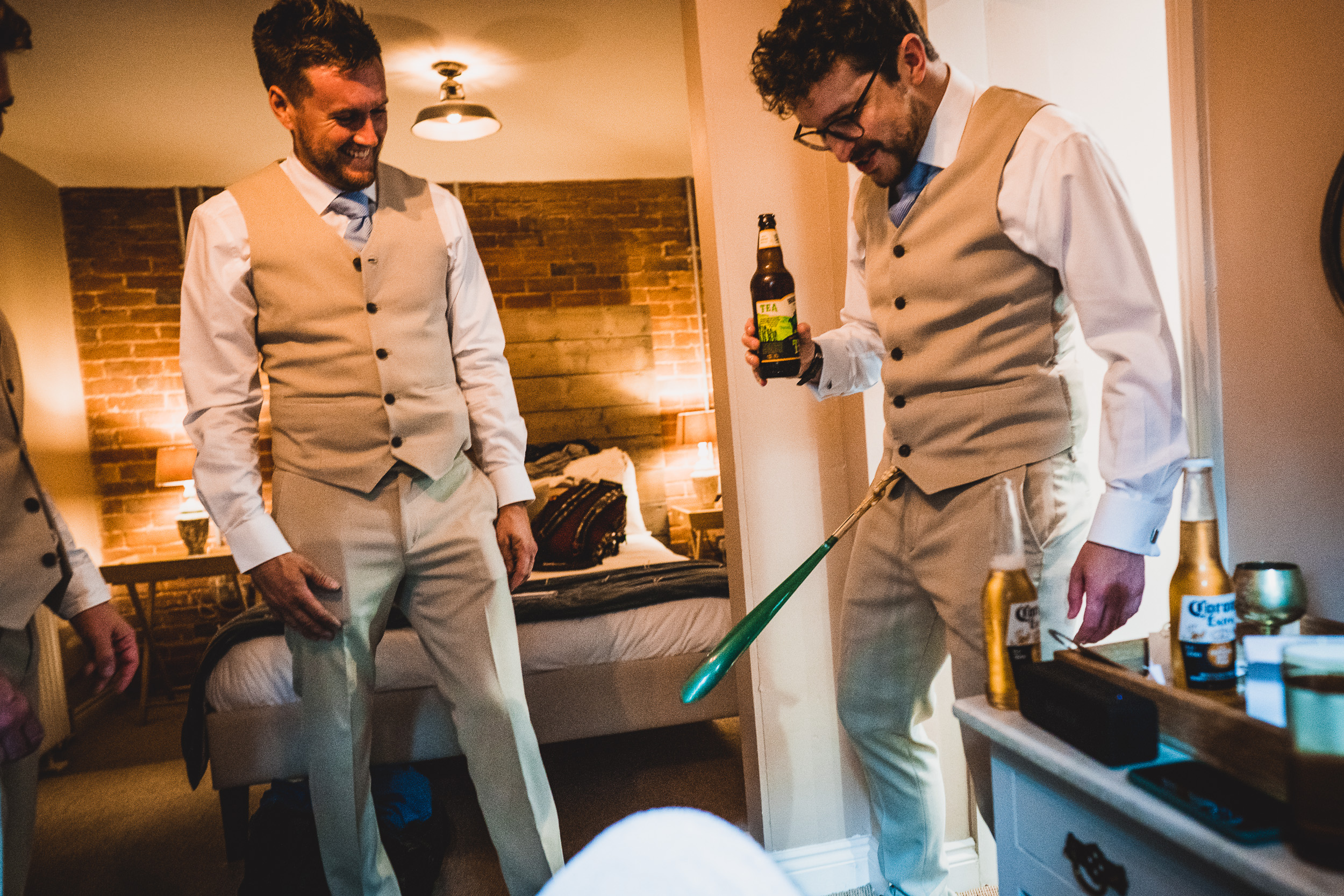 Groom and groomsmen preparing for wedding photo.