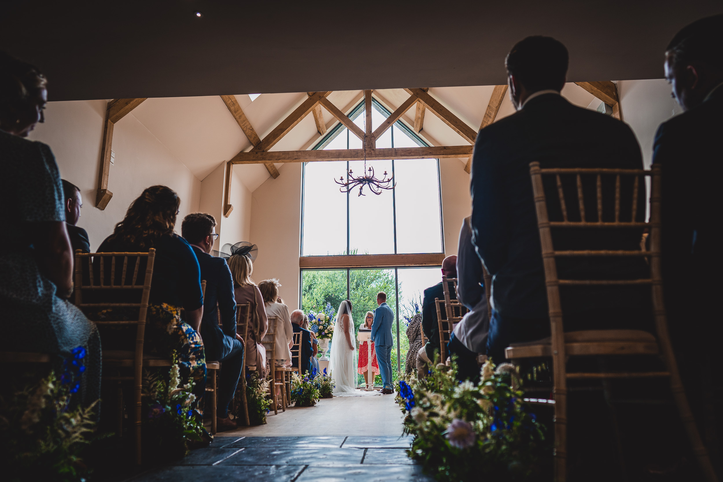 A rustic wedding photo with a bride and groom in a barn.