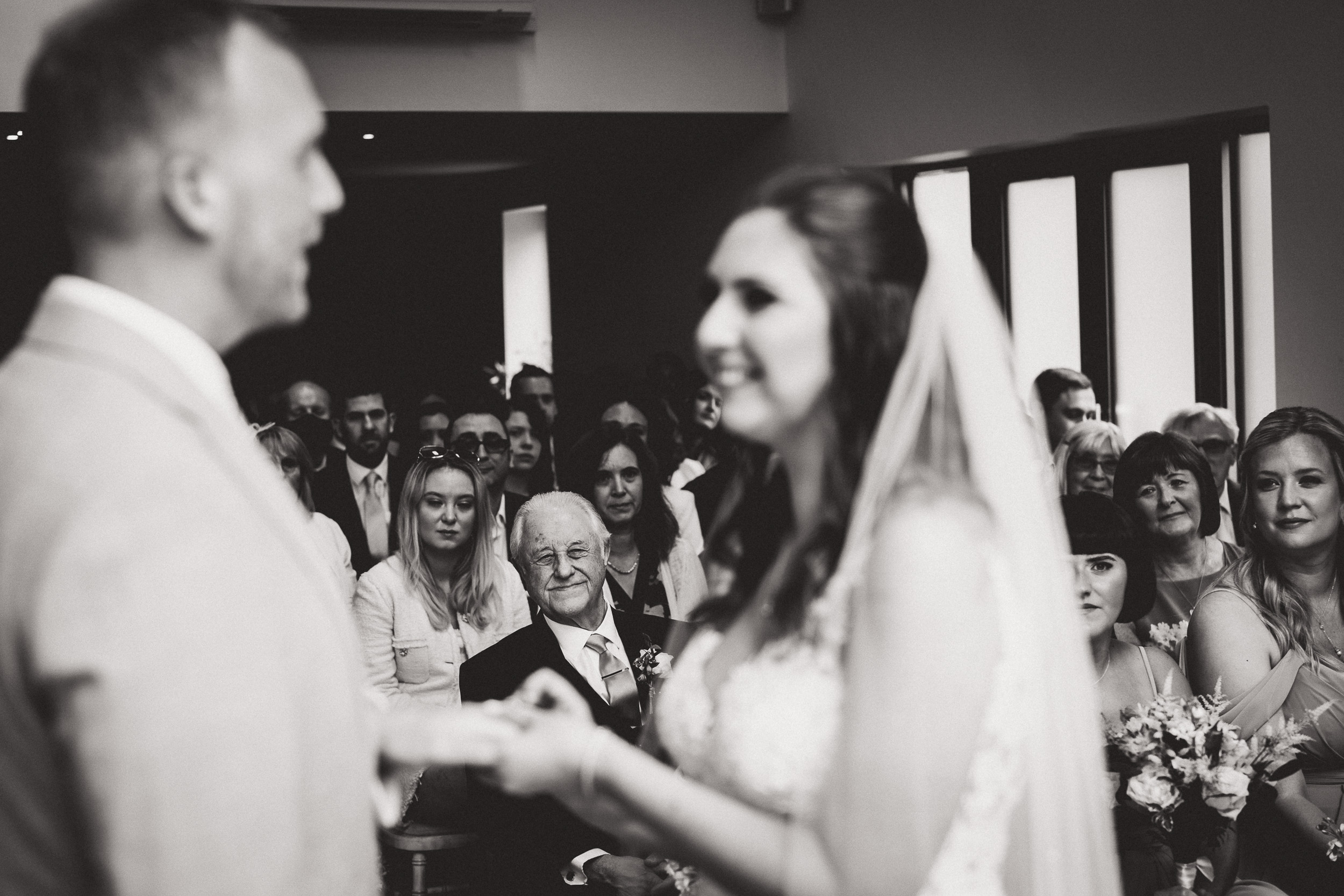 A groom exchanging vows with his bride at their wedding ceremony.