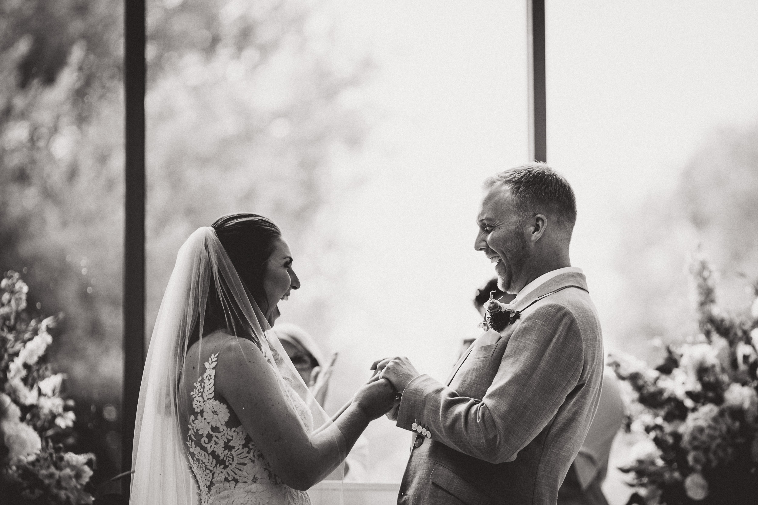 A groom and bride exchange wedding rings.