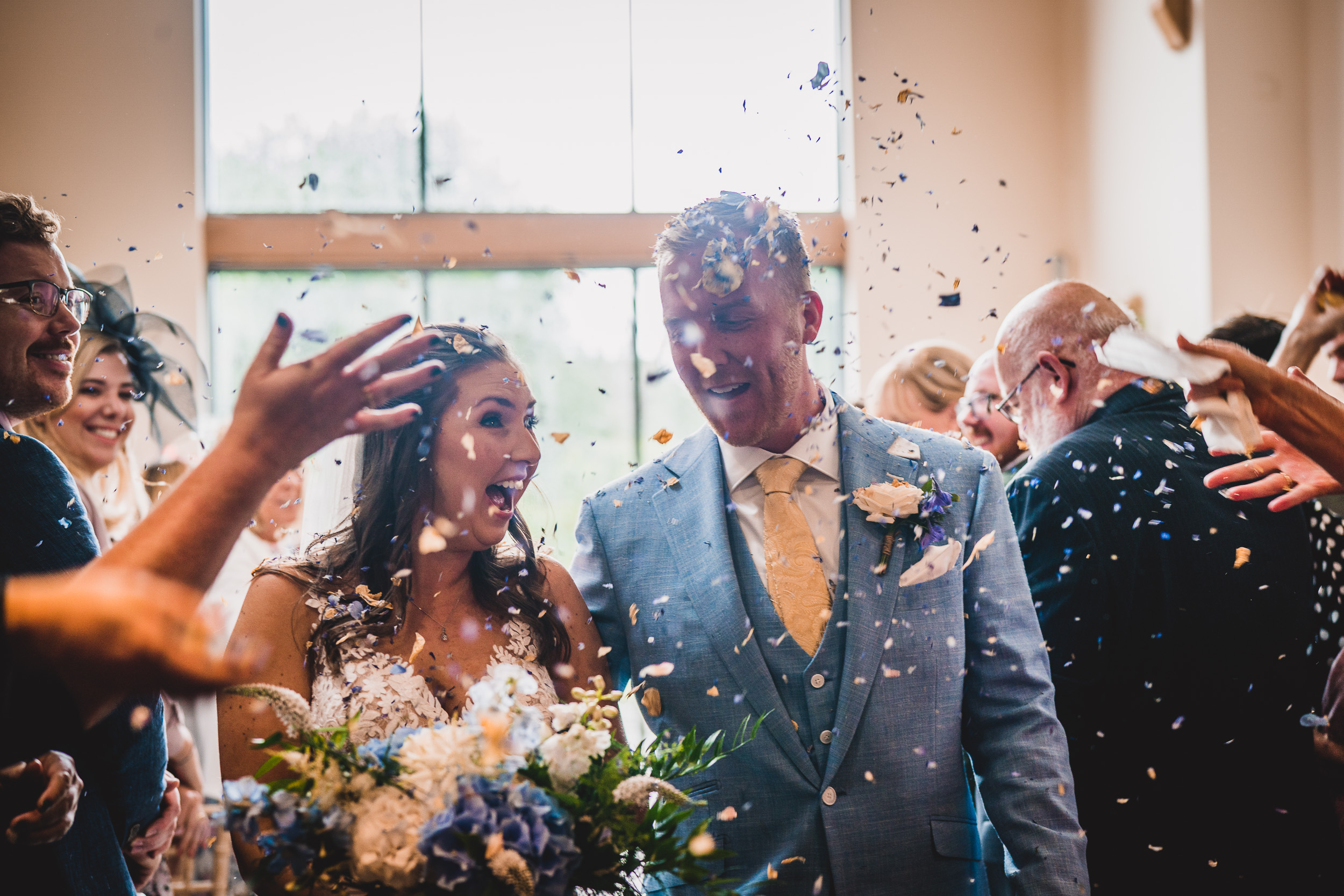 A groom being captured by a wedding photographer in a memorable wedding photo.