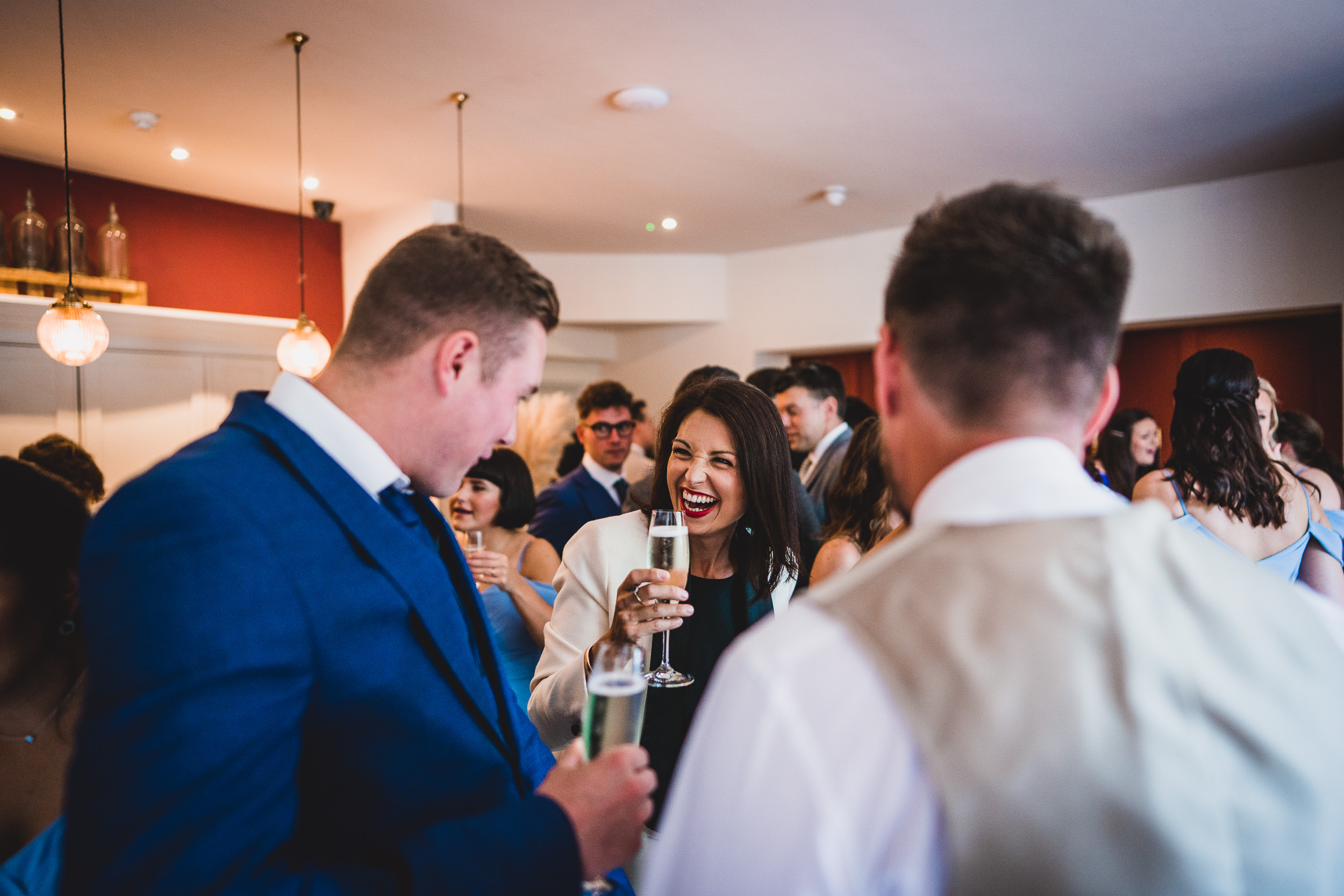 A wedding photo capturing the bride and groom celebrating with champagne at their reception.