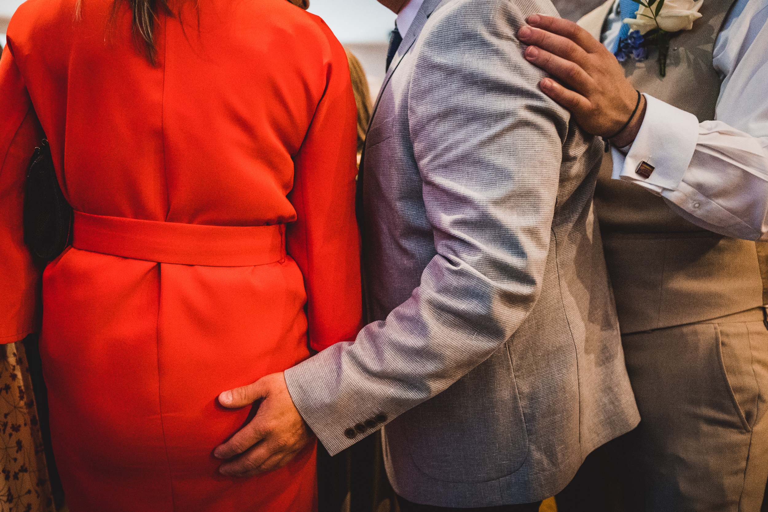 A groom with a group of people in a wedding photo.