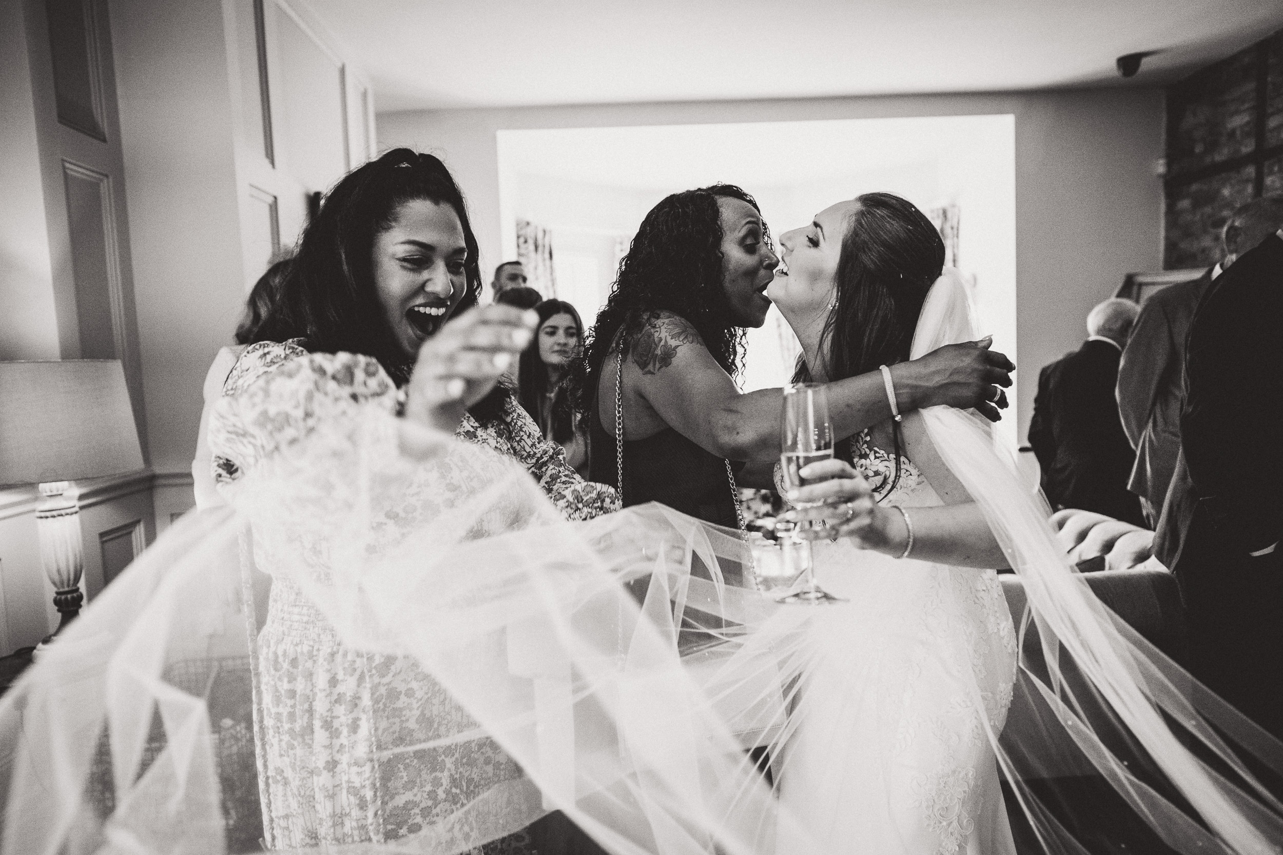 A bride and her bridesmaids posing in the living room for a wedding photo.