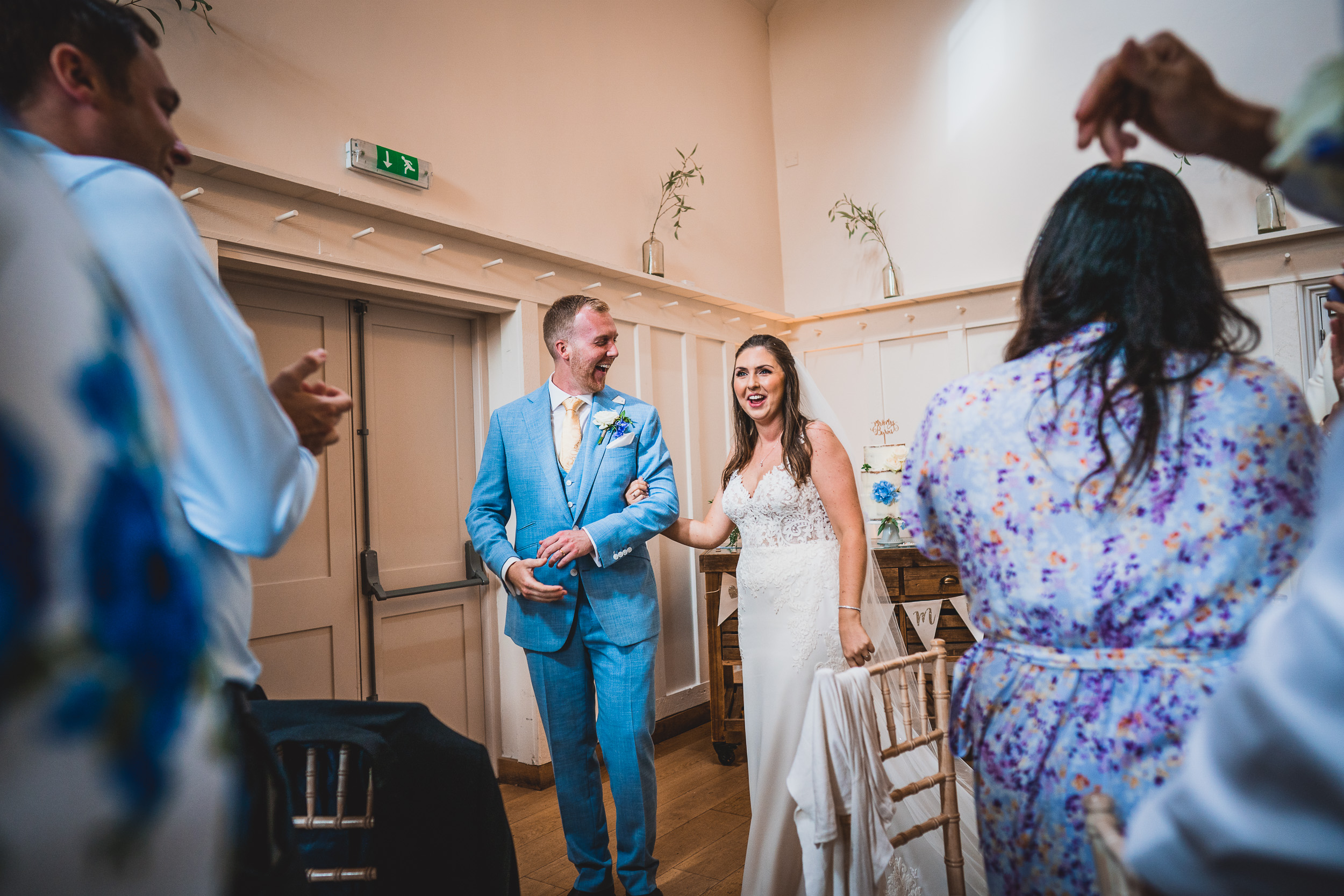 A wedding photographer capturing a bride and groom walking down the aisle.