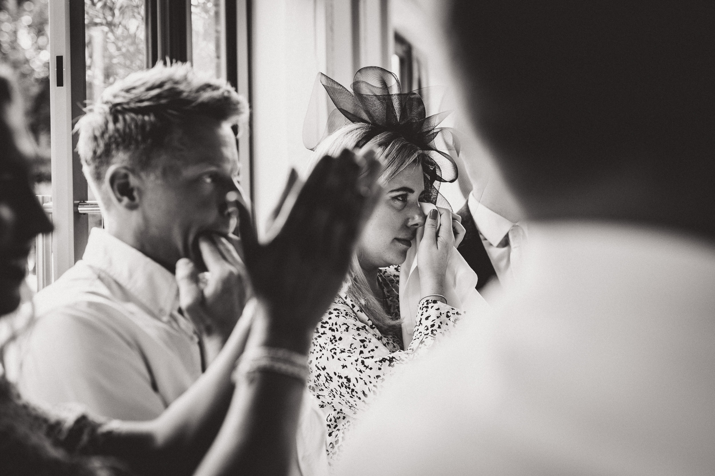 A wedding ceremony with a clapping groom and bride.