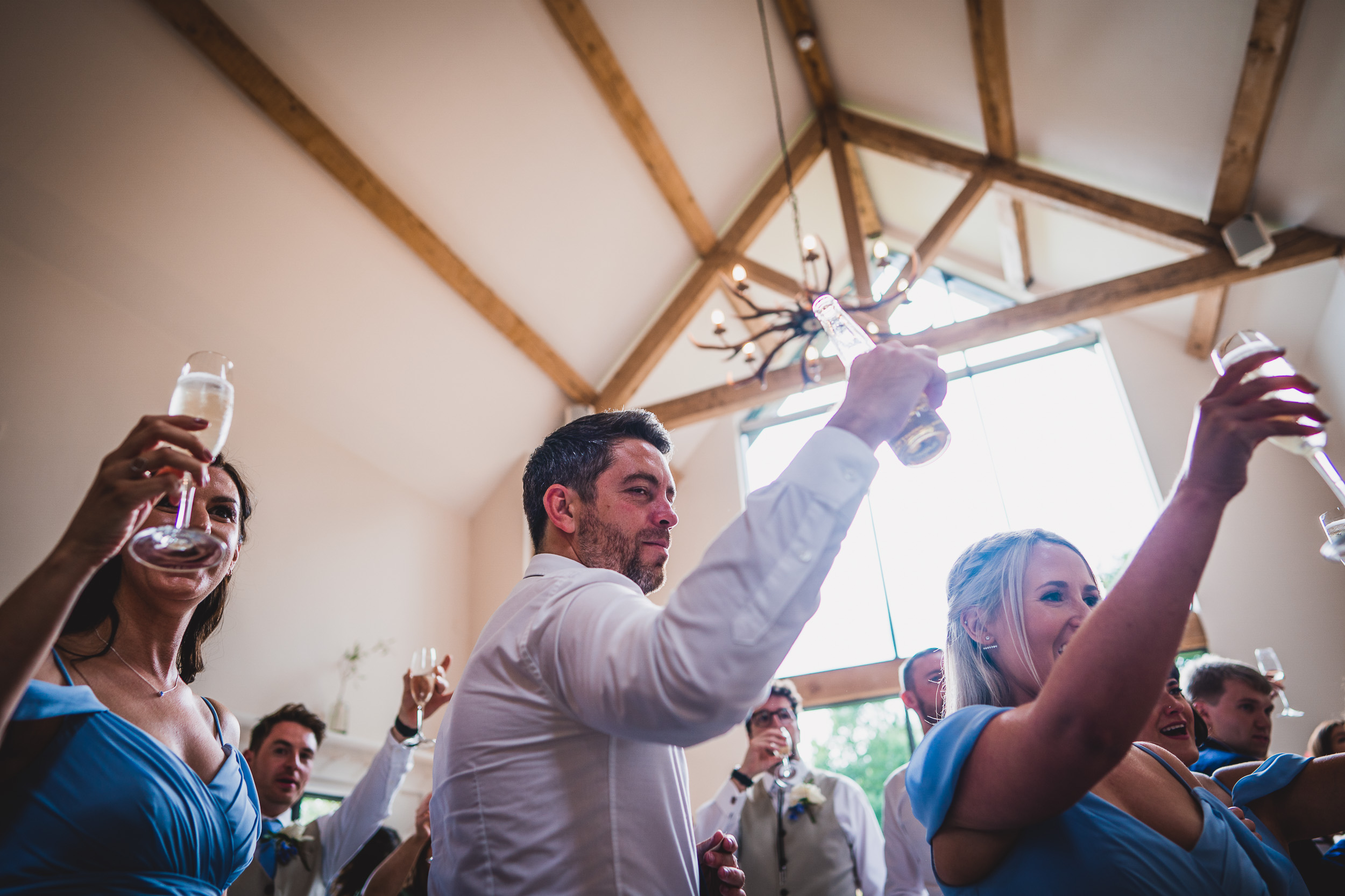 A bride and groom toasting champagne at their wedding reception.