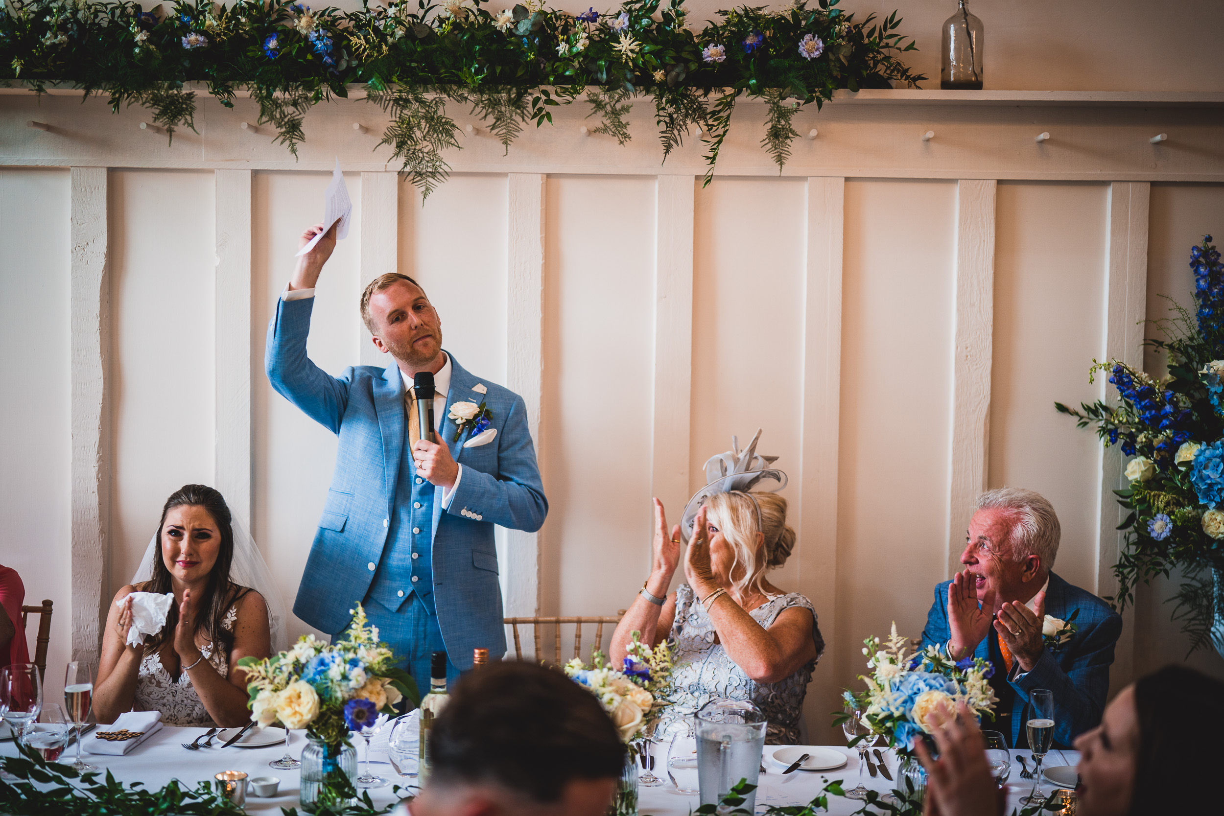 A groom gives a speech during the wedding reception.