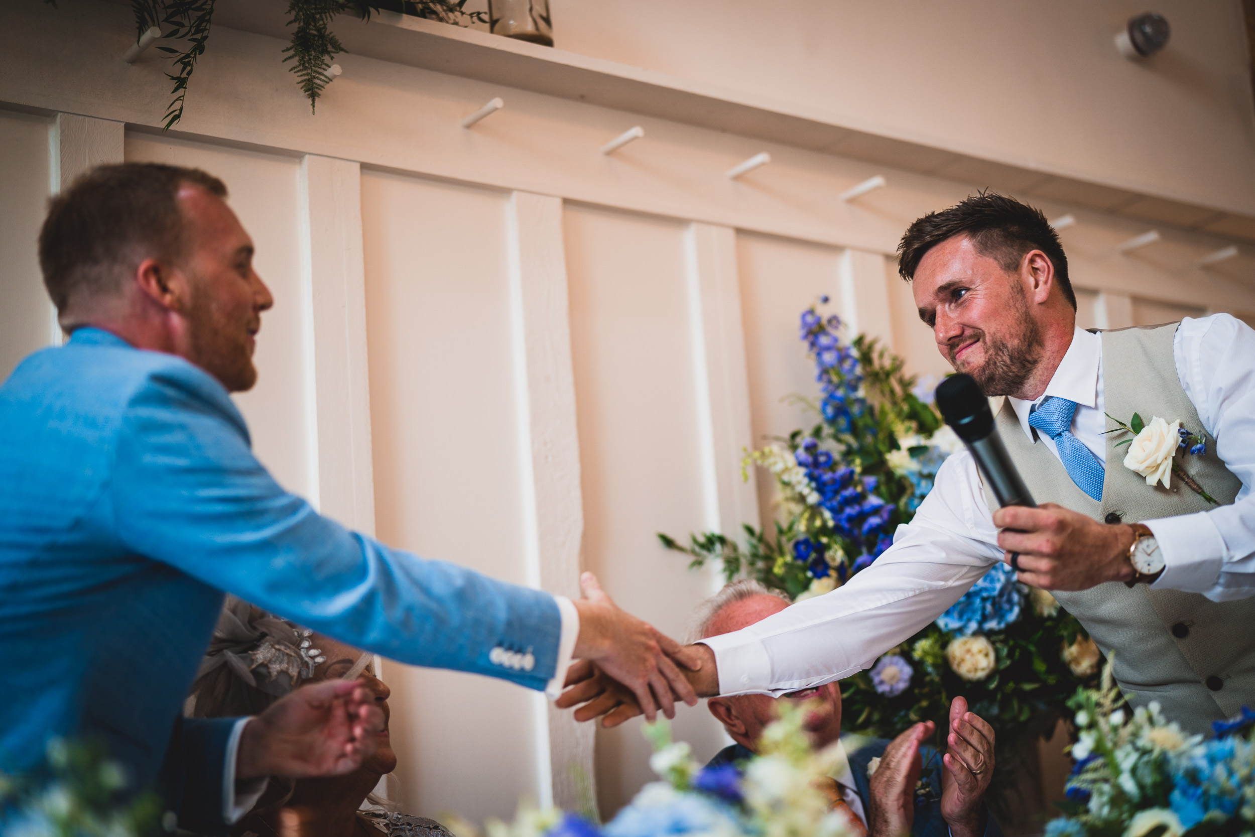 Two groomsmen posing for a wedding photo.