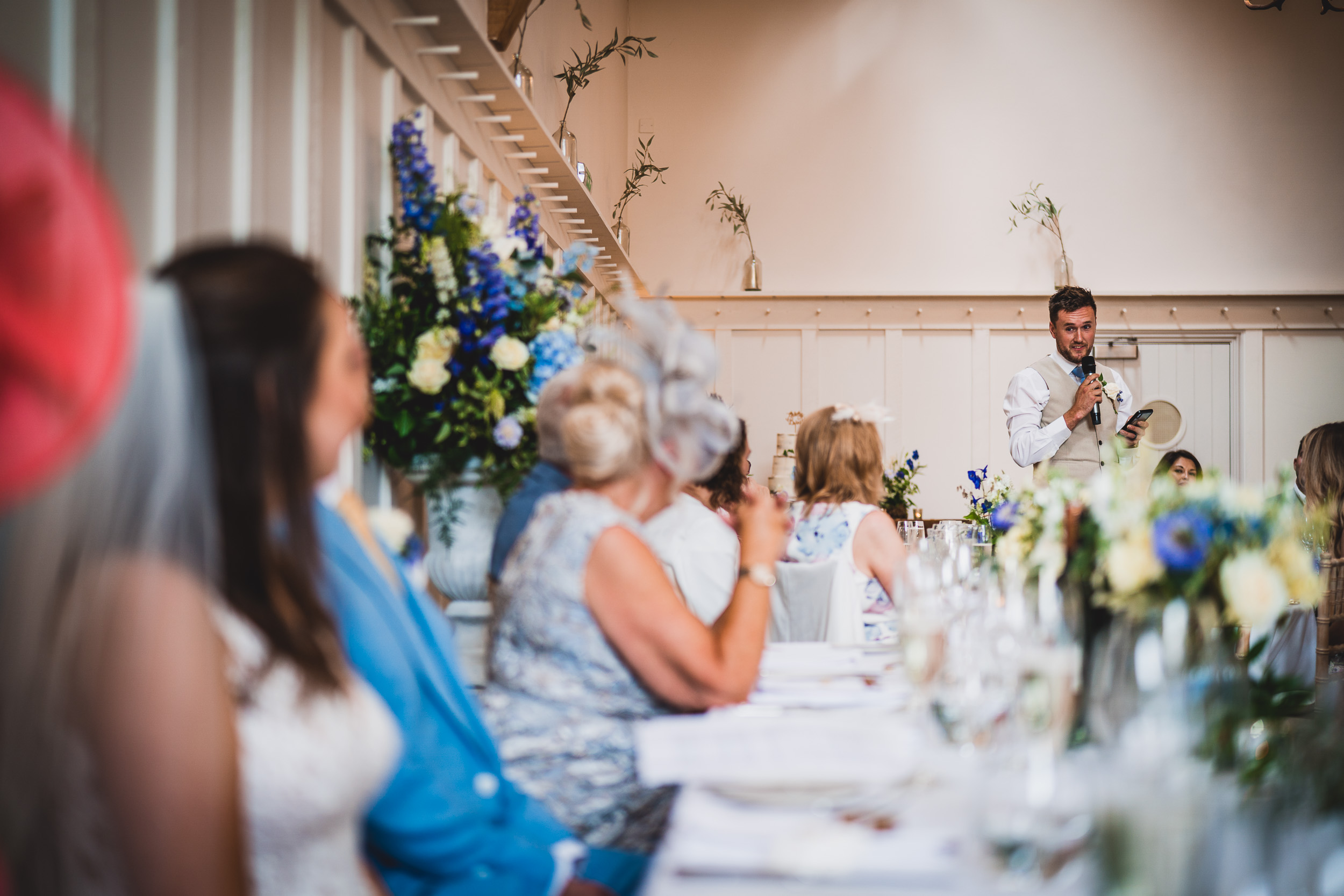 A man delivering a toast at a wedding reception.