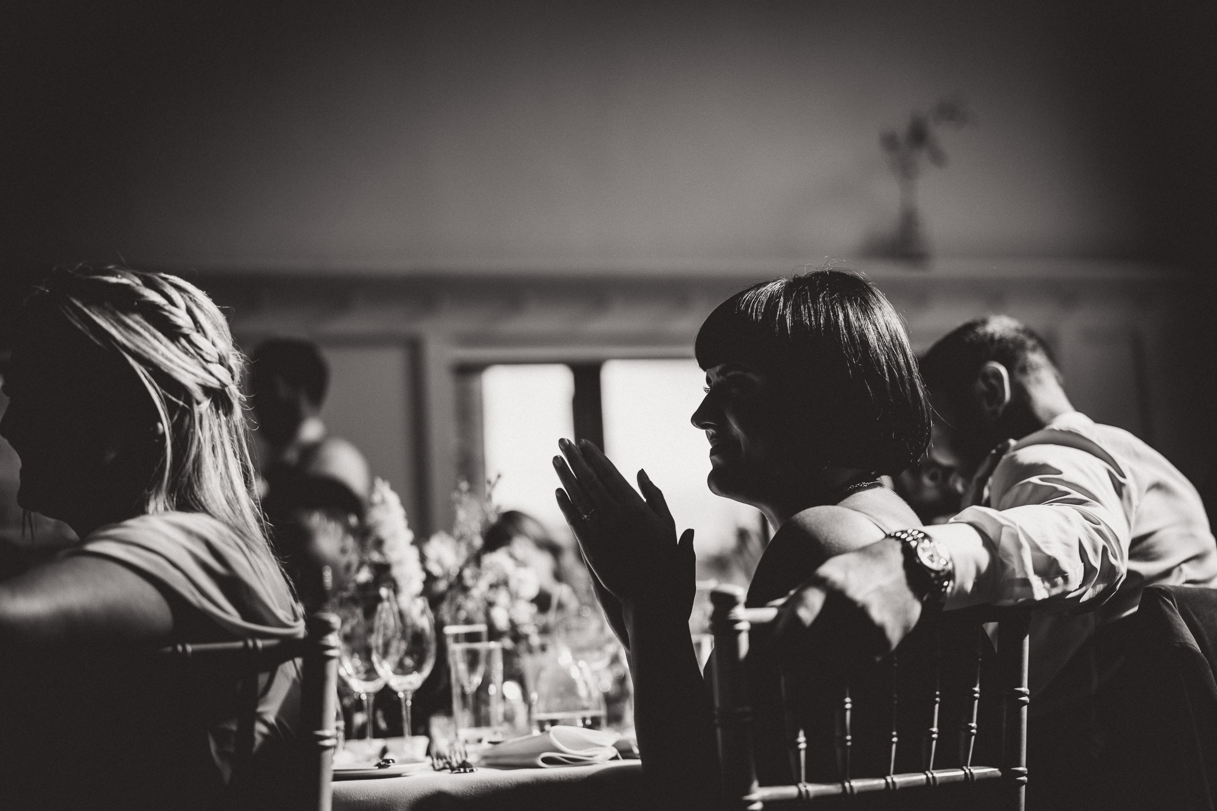 A wedding photo capturing people clapping in black and white.