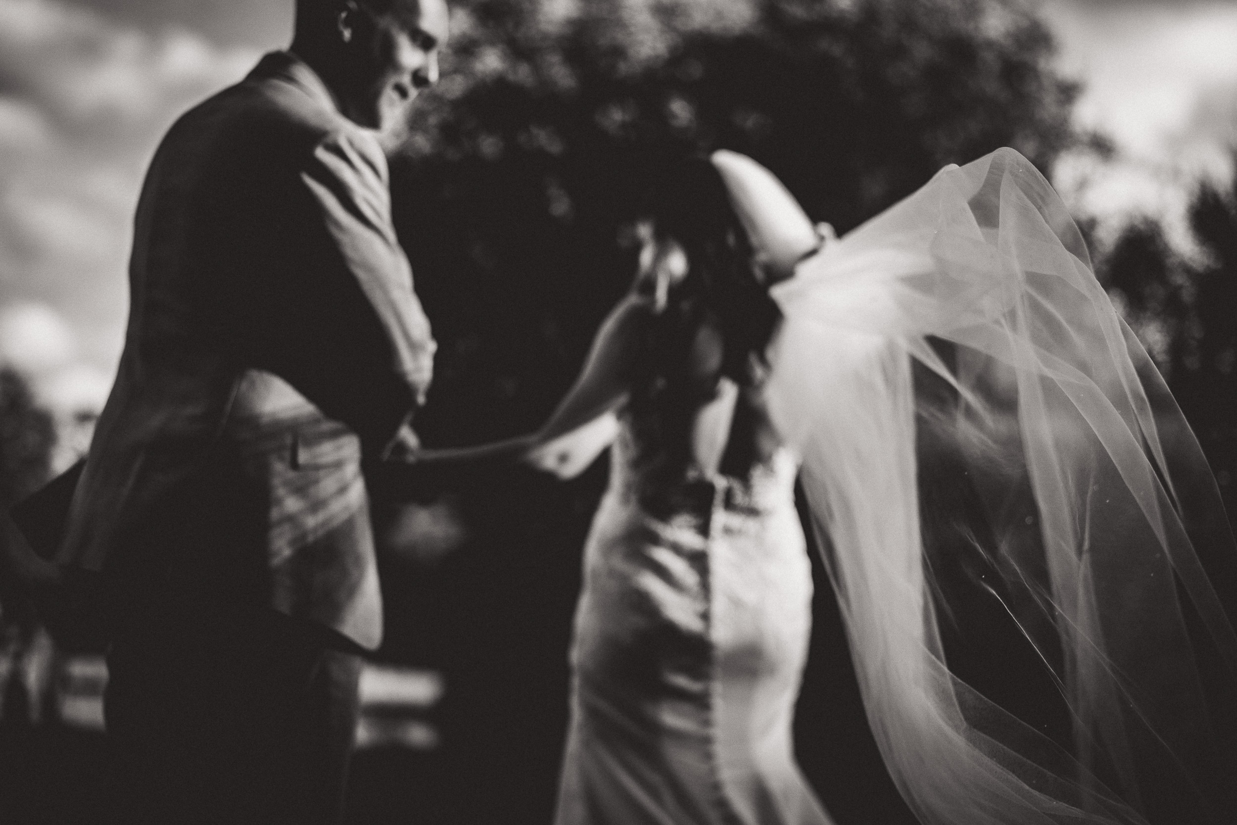 A captured moment of a bride and groom in a timeless black and white wedding photograph.