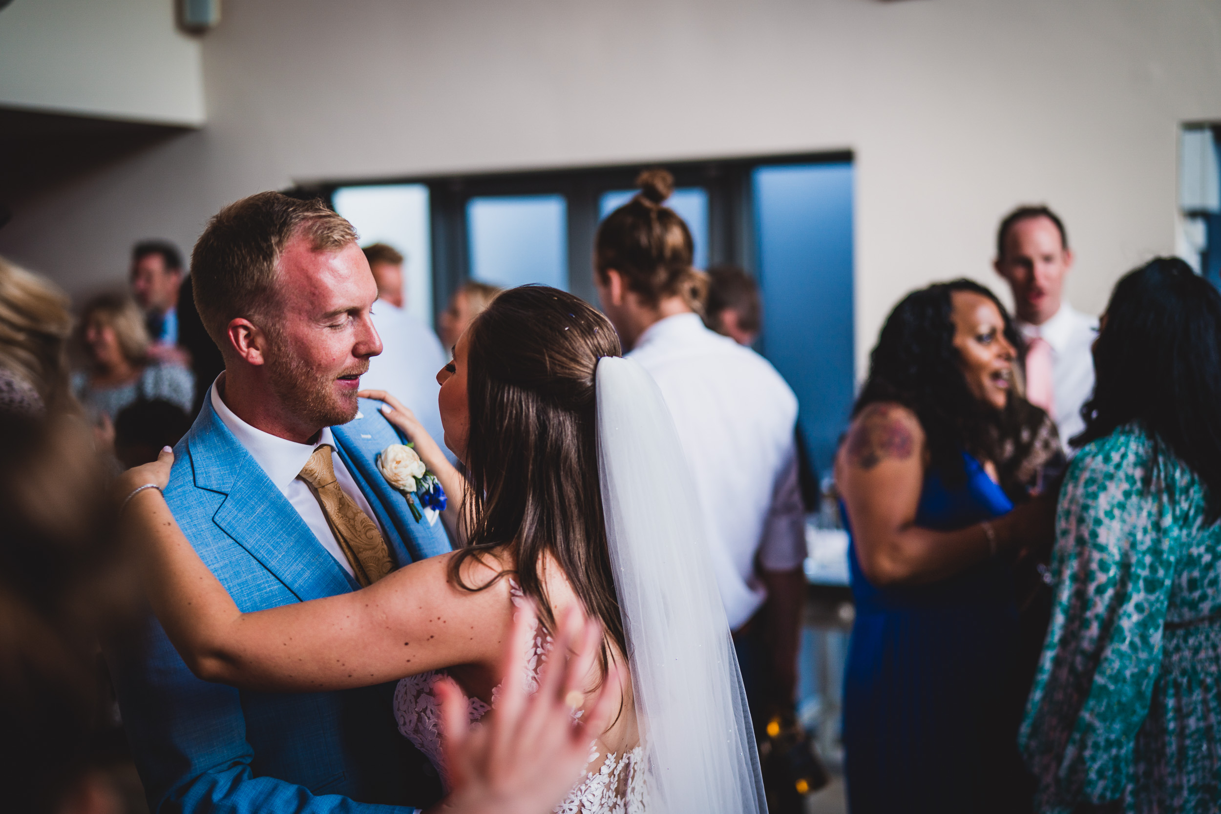 A groom and bride joyfully dance at their wedding reception, captured in a stunning wedding photo.