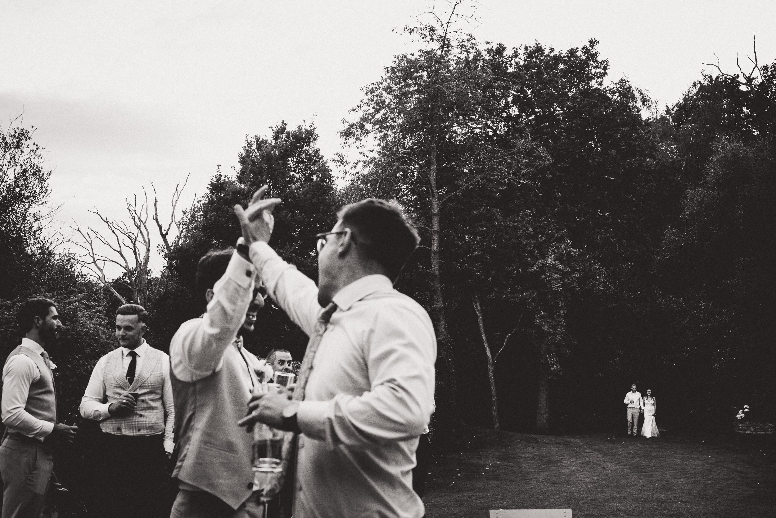 A wedding photo capturing a group of people in black and white.