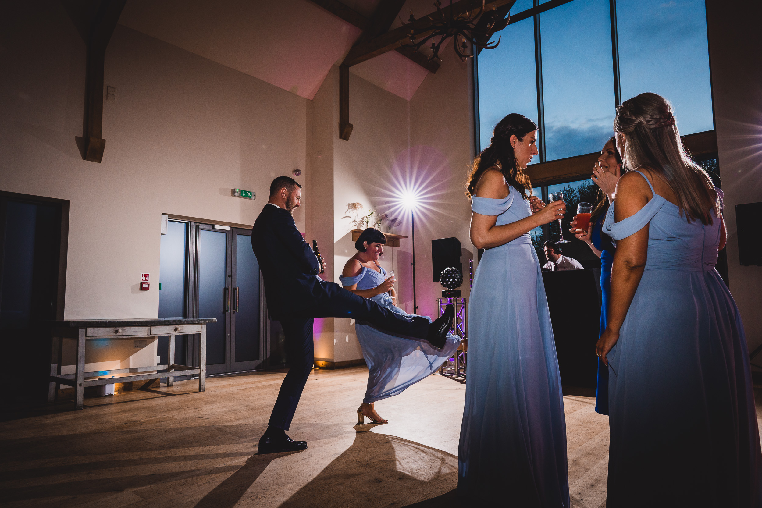 A group of bridesmaids dancing, captured by a wedding photographer.