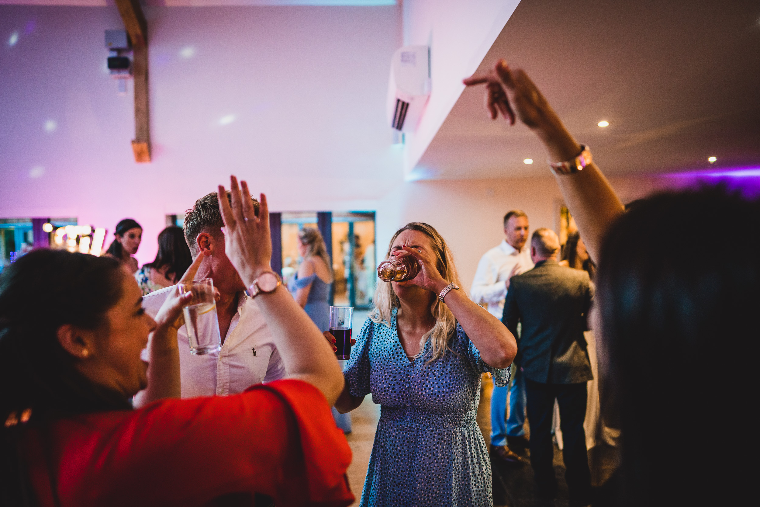 A groom and bride dancing at their wedding reception, captured by a wedding photographer.