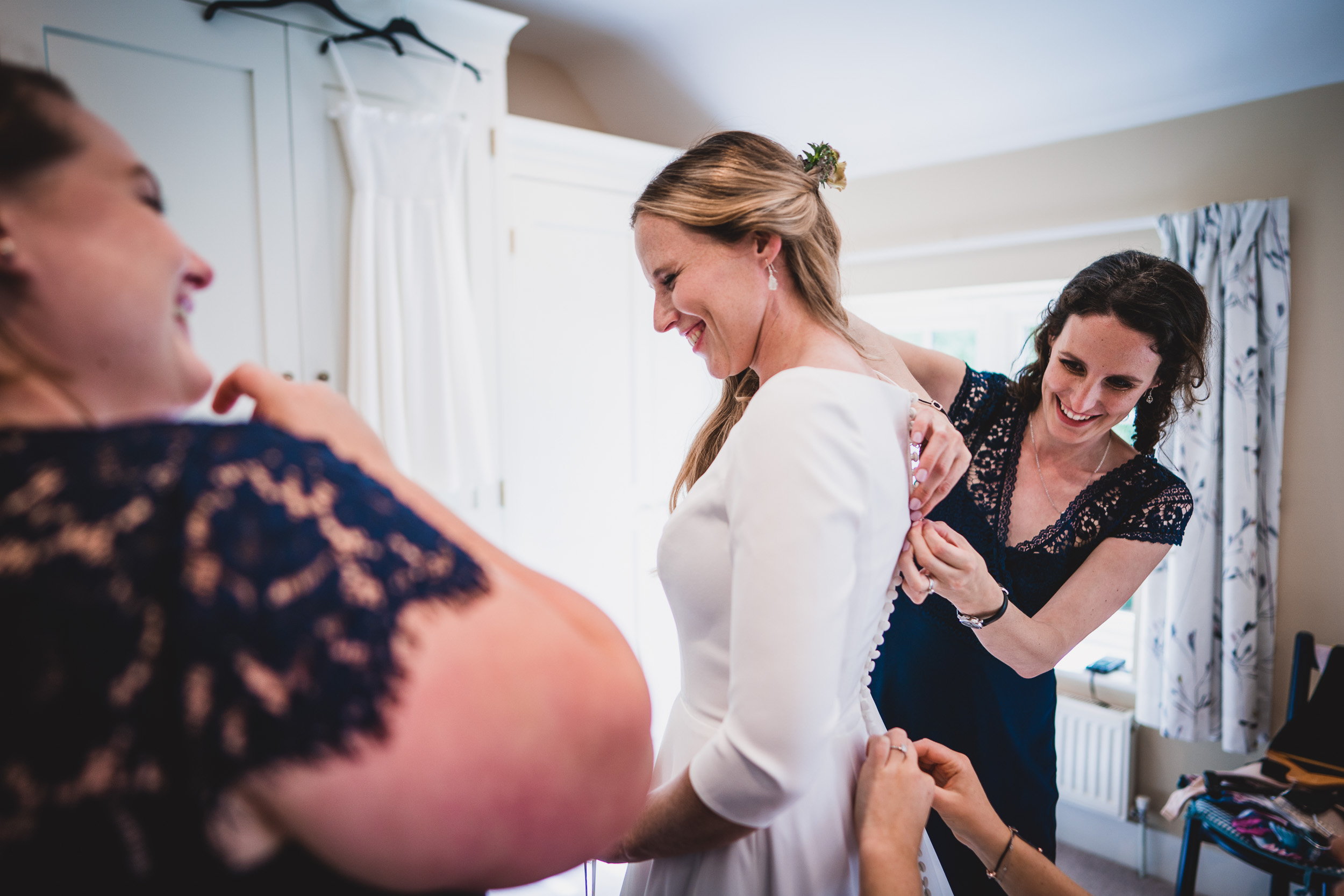 A bride getting ready for her wedding with her bridesmaids.