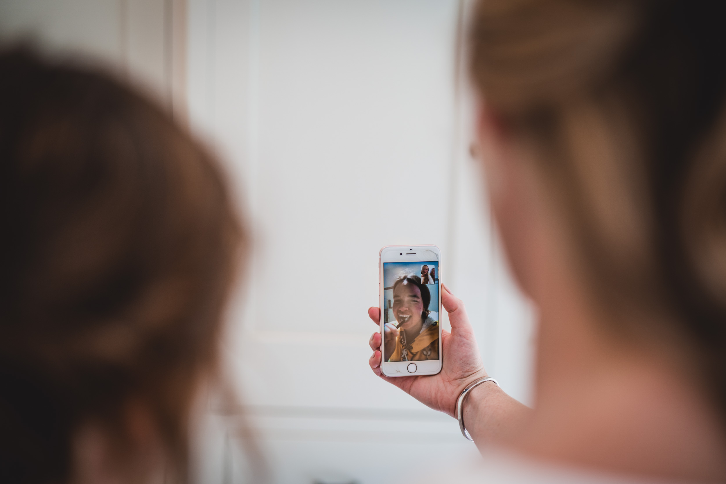 A wedding photographer captures a self-portrait on her cell phone.