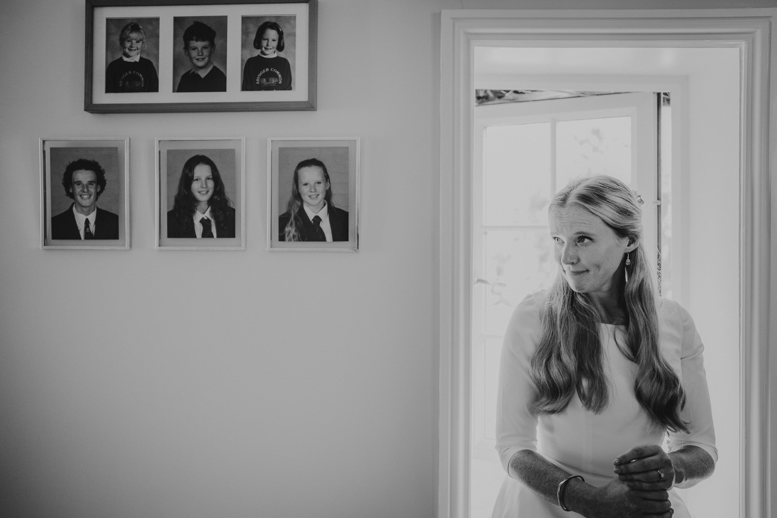 A wedding photo capturing a bride in a doorway, taken by a wedding photographer.