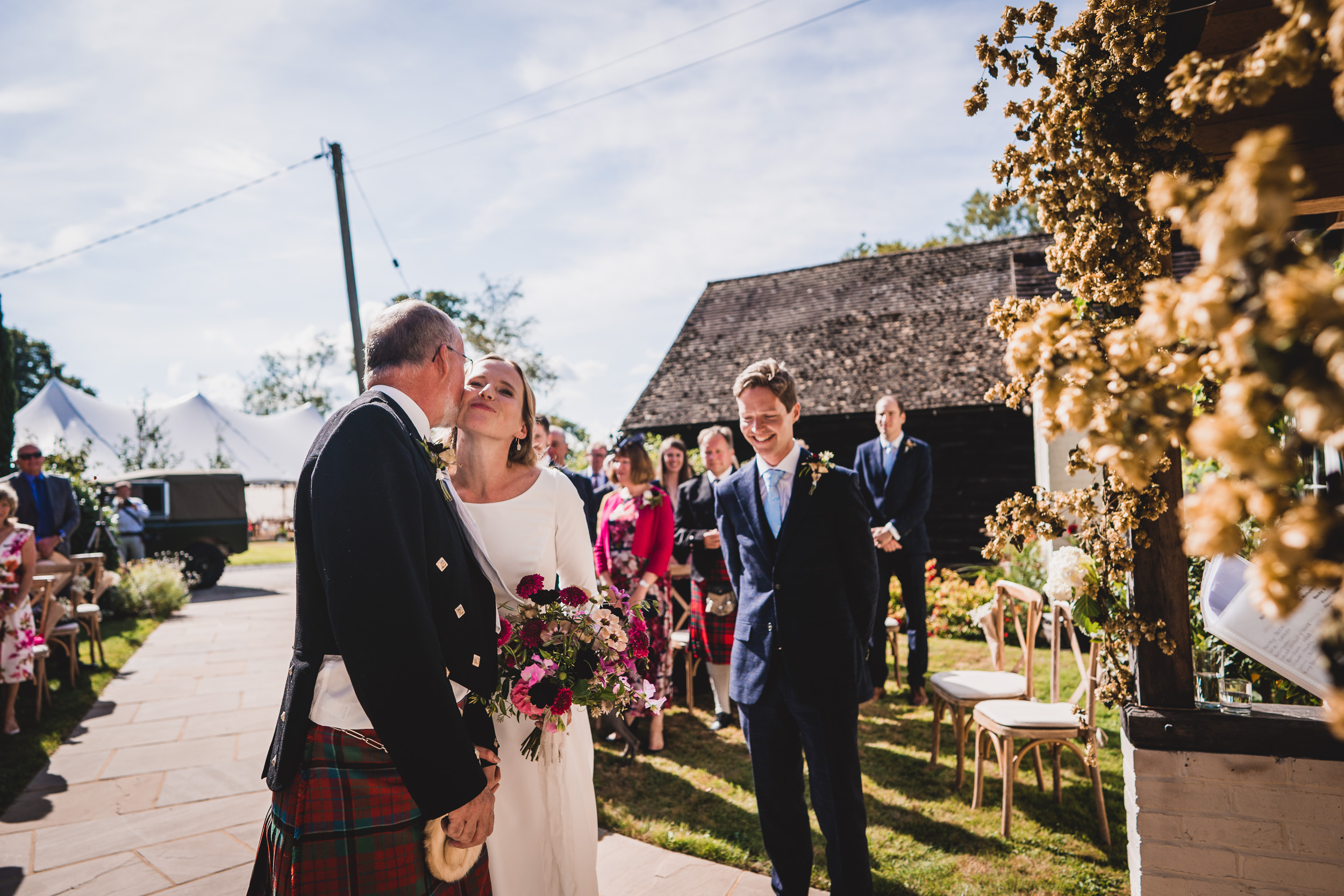 A romantic wedding photo capturing the kiss between the groom and bride.