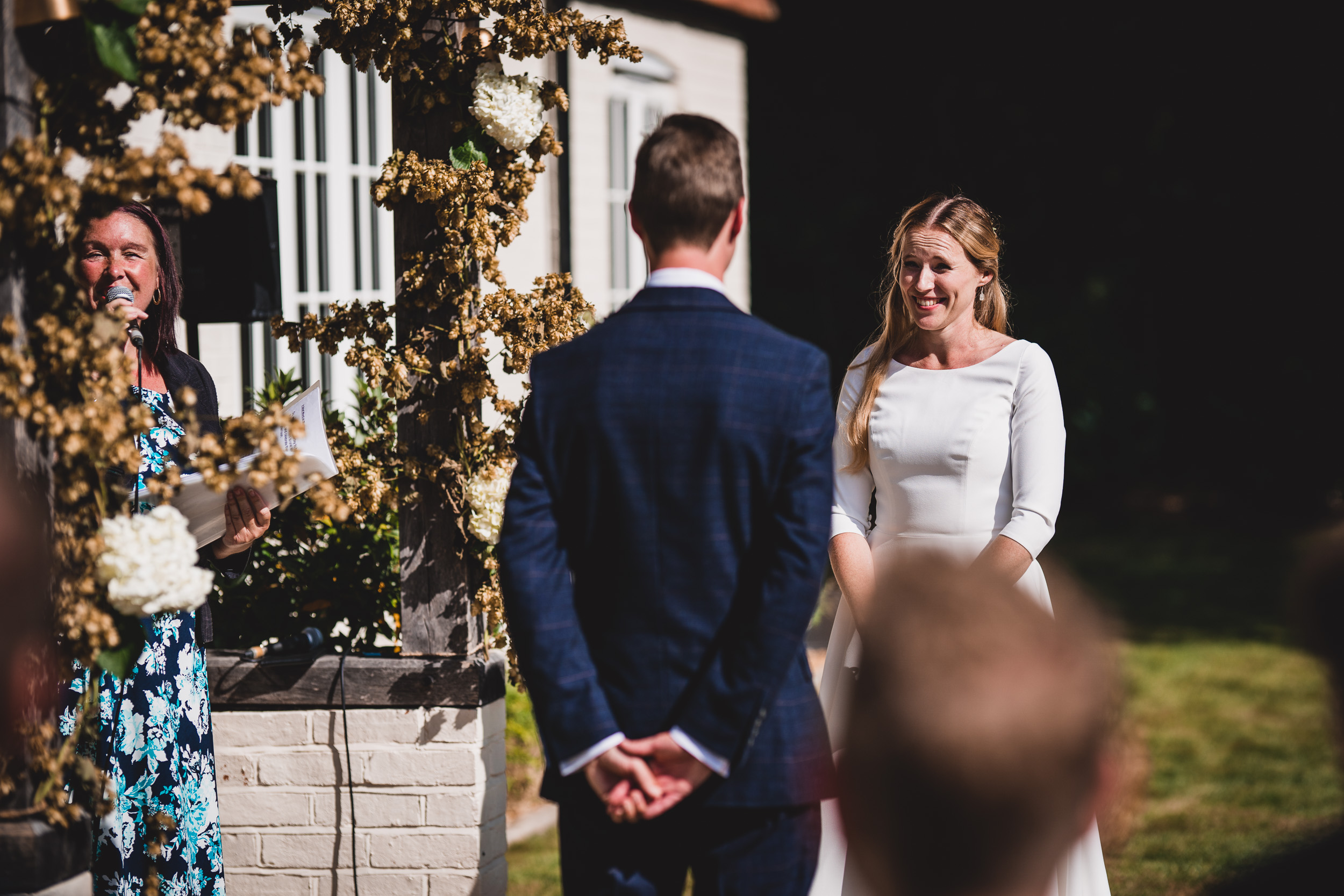 A wedding photographer captures the bride and groom's loving gaze during their ceremony.