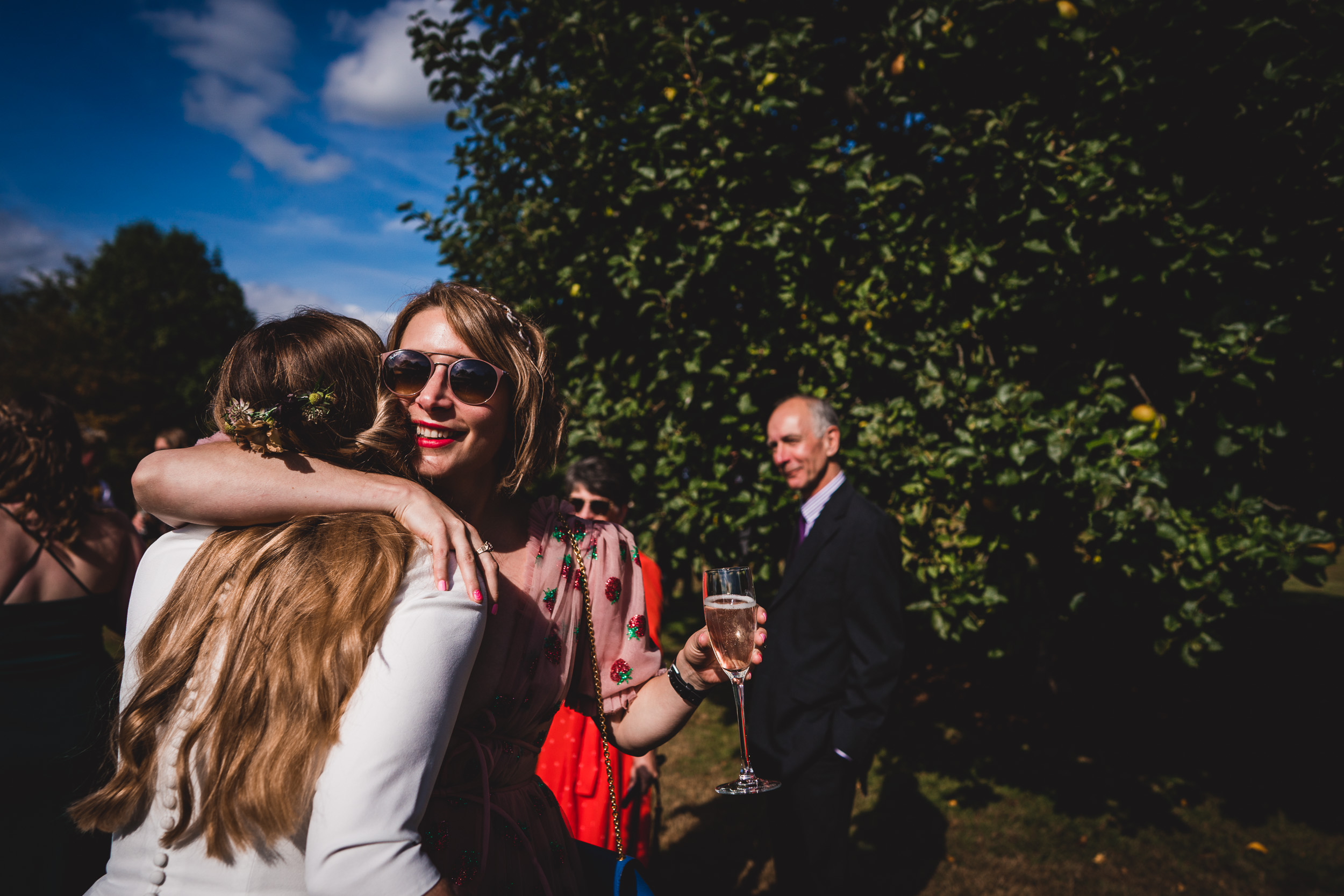 A wedding couple embracing near an orange tree.