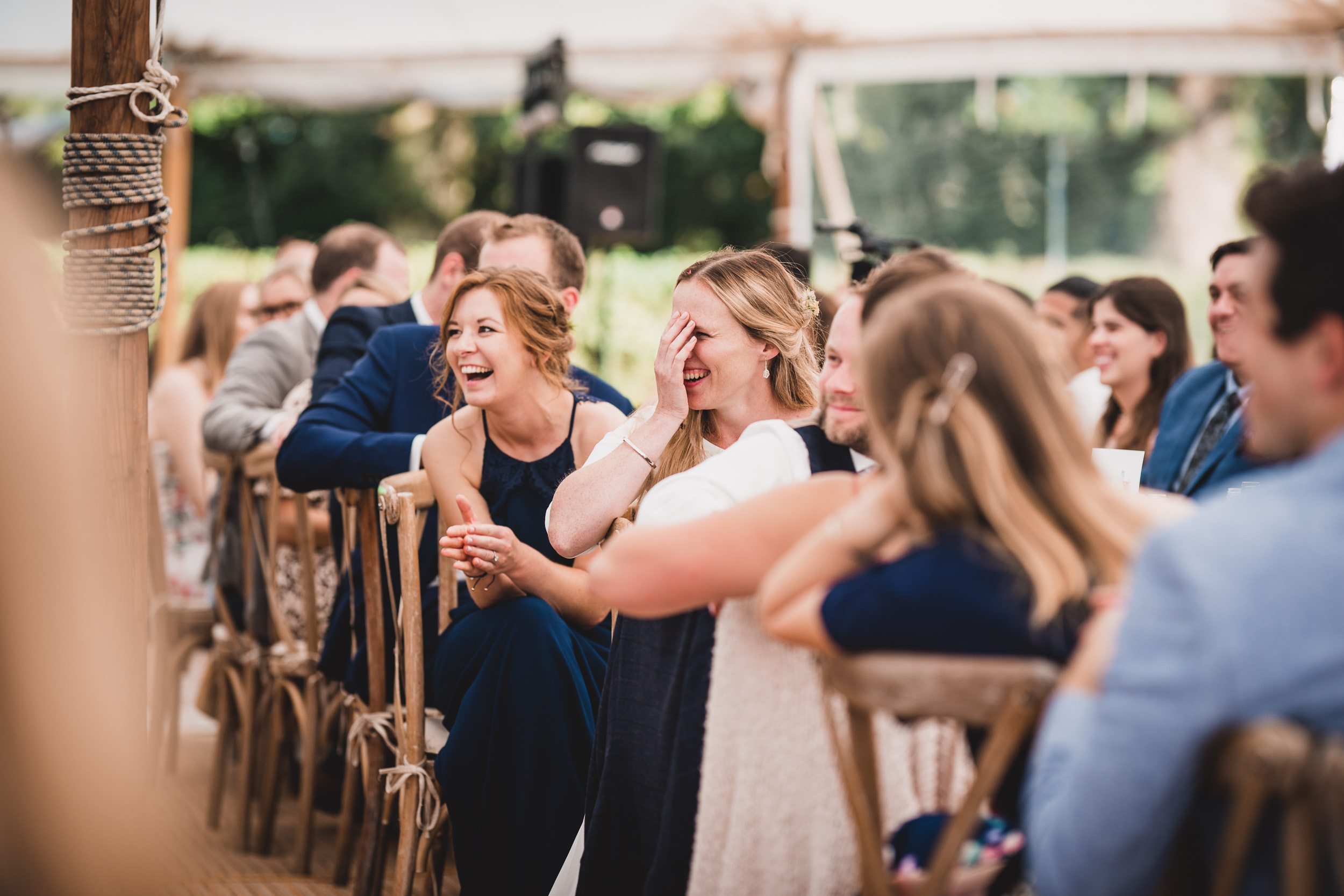 A wedding photographer captures a joyful bride and groom during their ceremony.