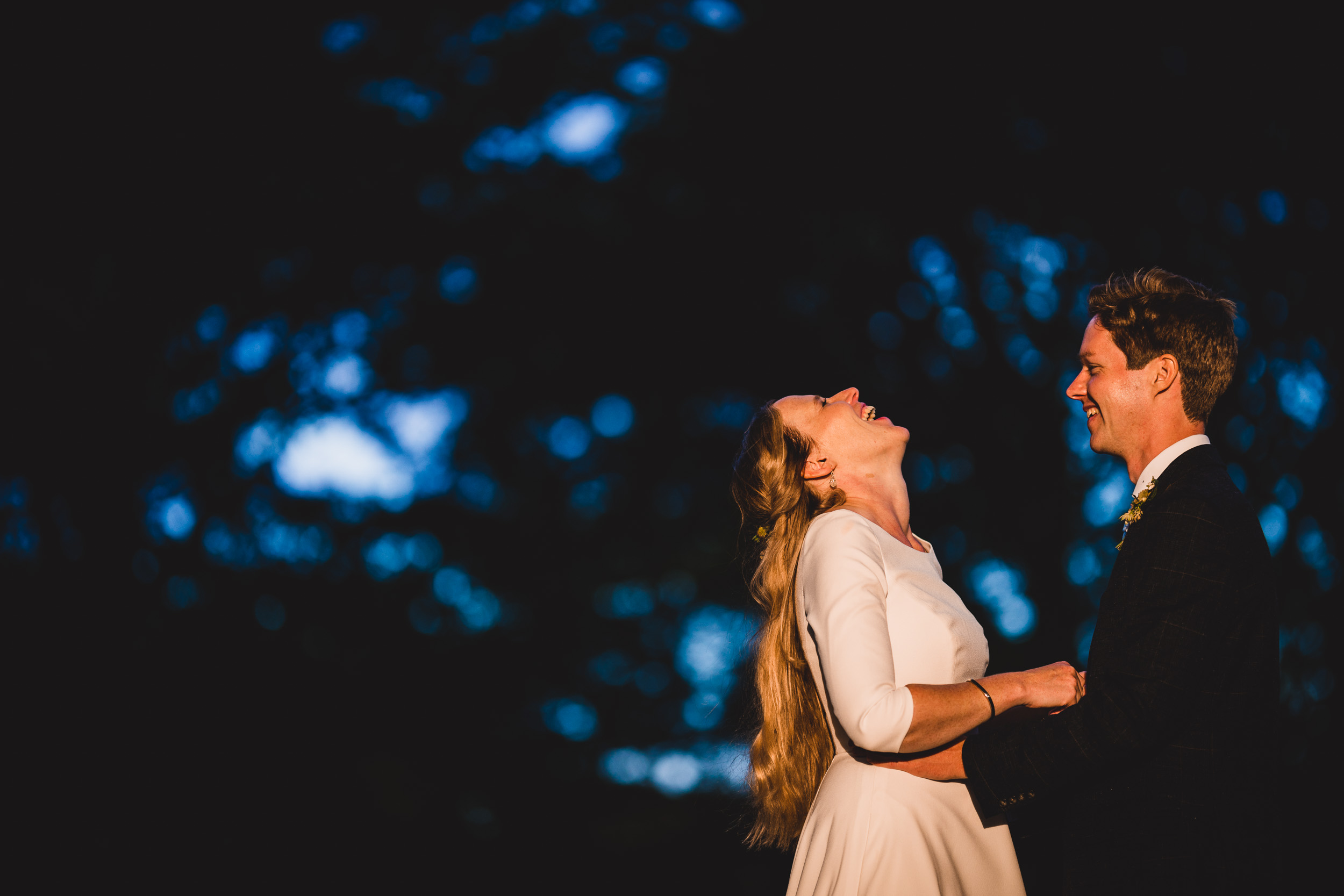 A couple exchanging vows in a dimly lit wedding ceremony.