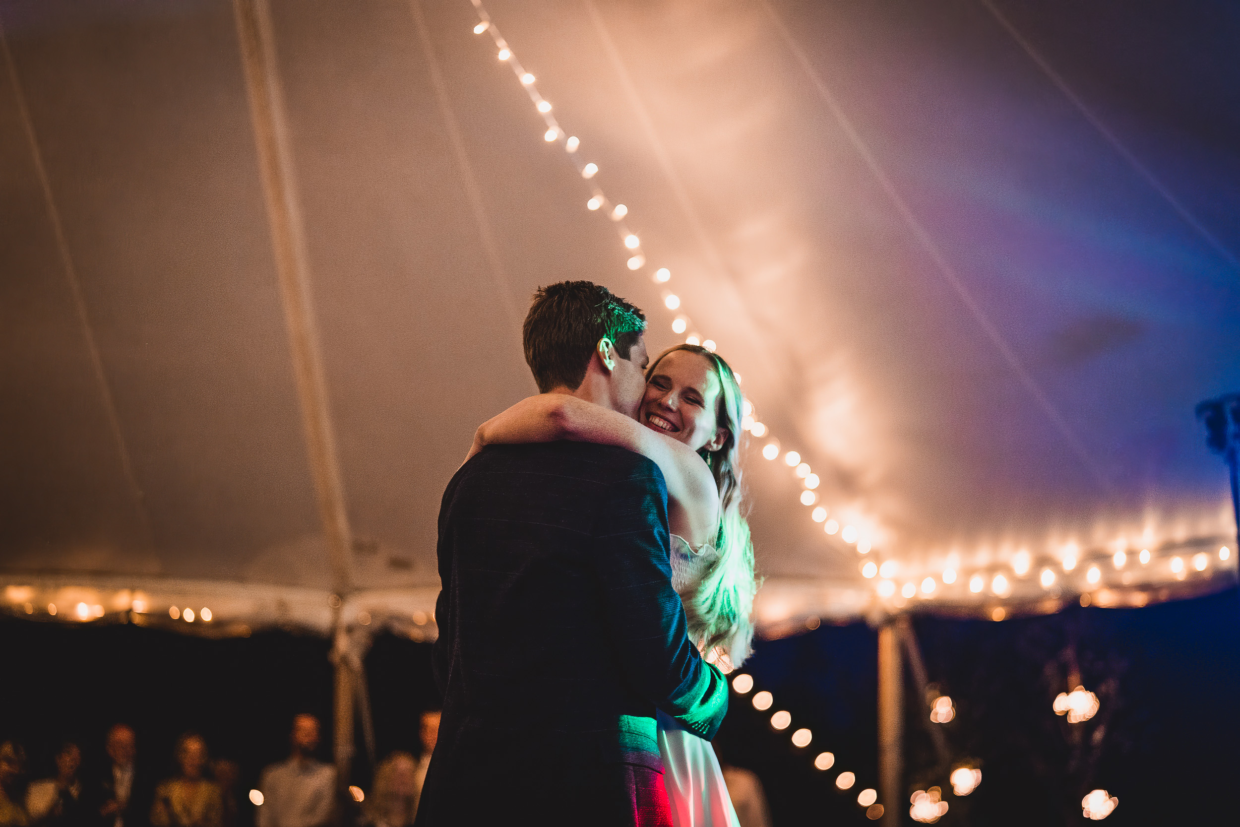 A bride and groom sharing their first dance in a wedding photo.