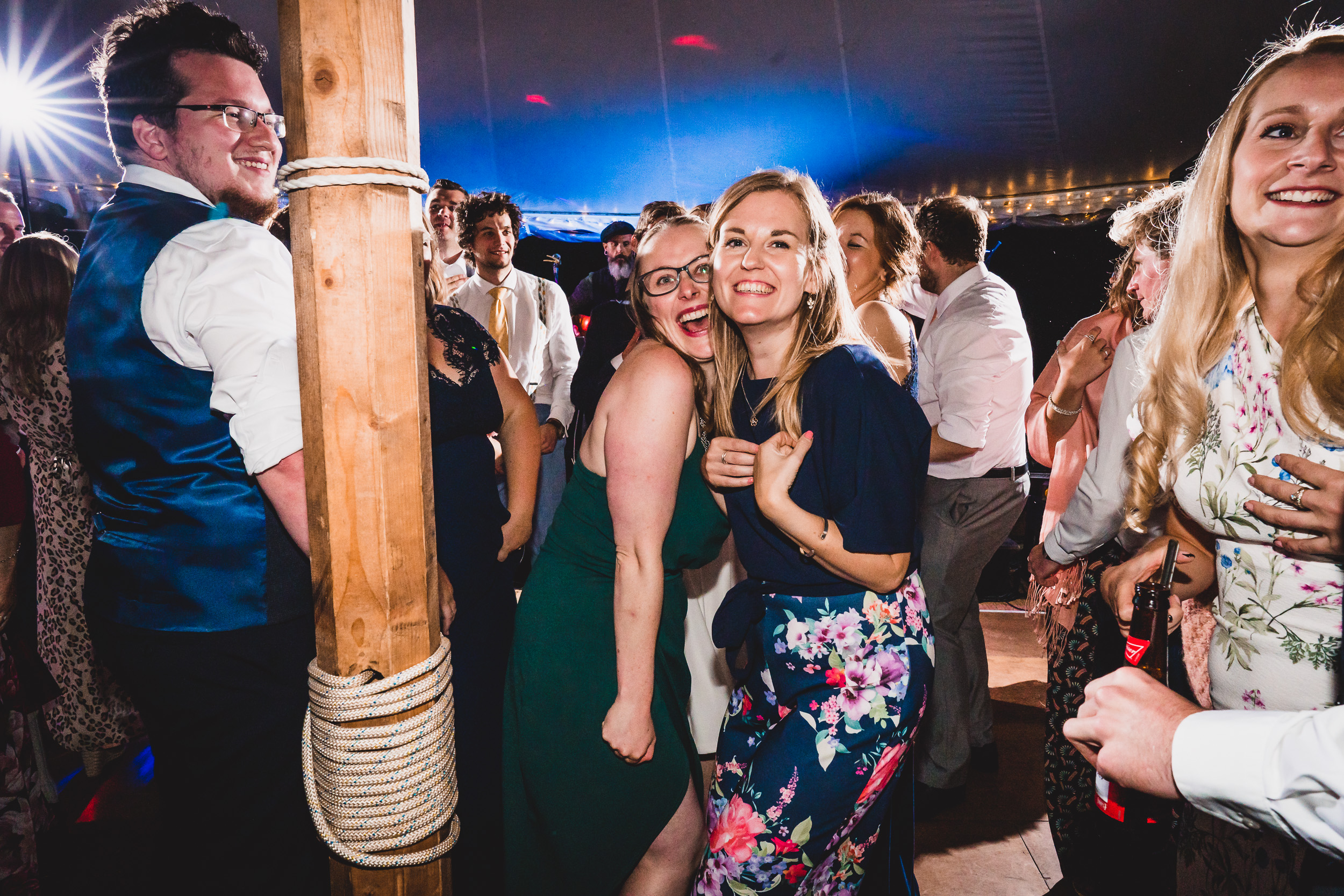 A group of people dancing at a wedding.