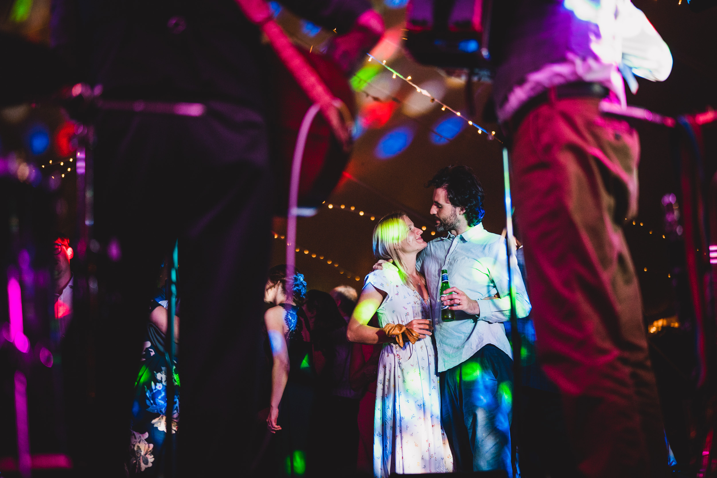 A couple kissing on stage during their wedding.