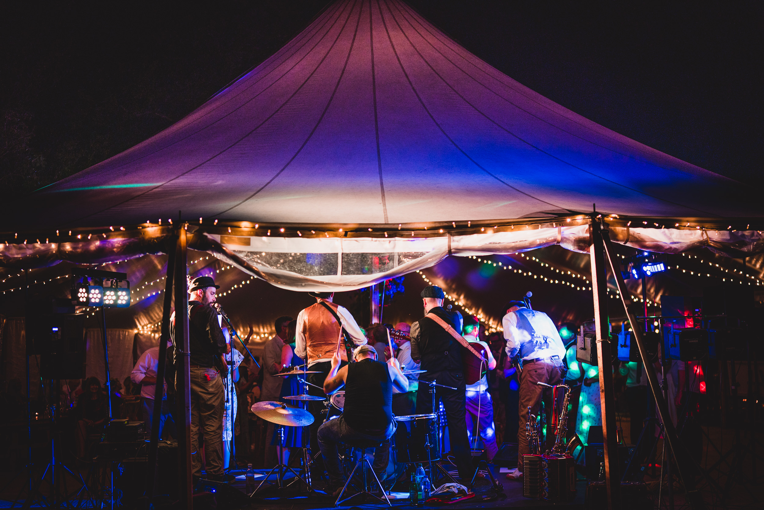 A group of people playing music at a wedding.