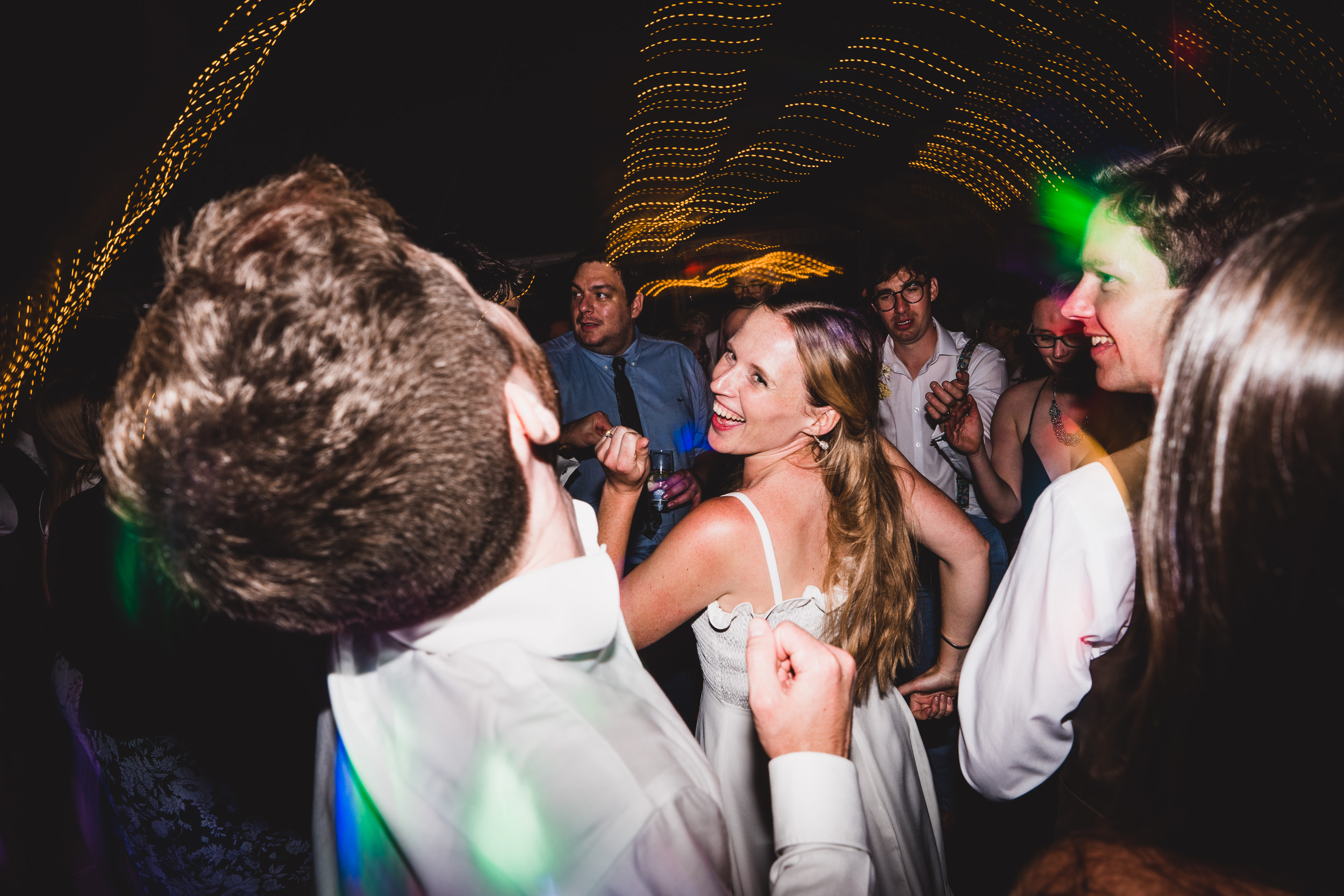 A bride and groom gracefully dance during their wedding reception, captured by a skilled wedding photographer.