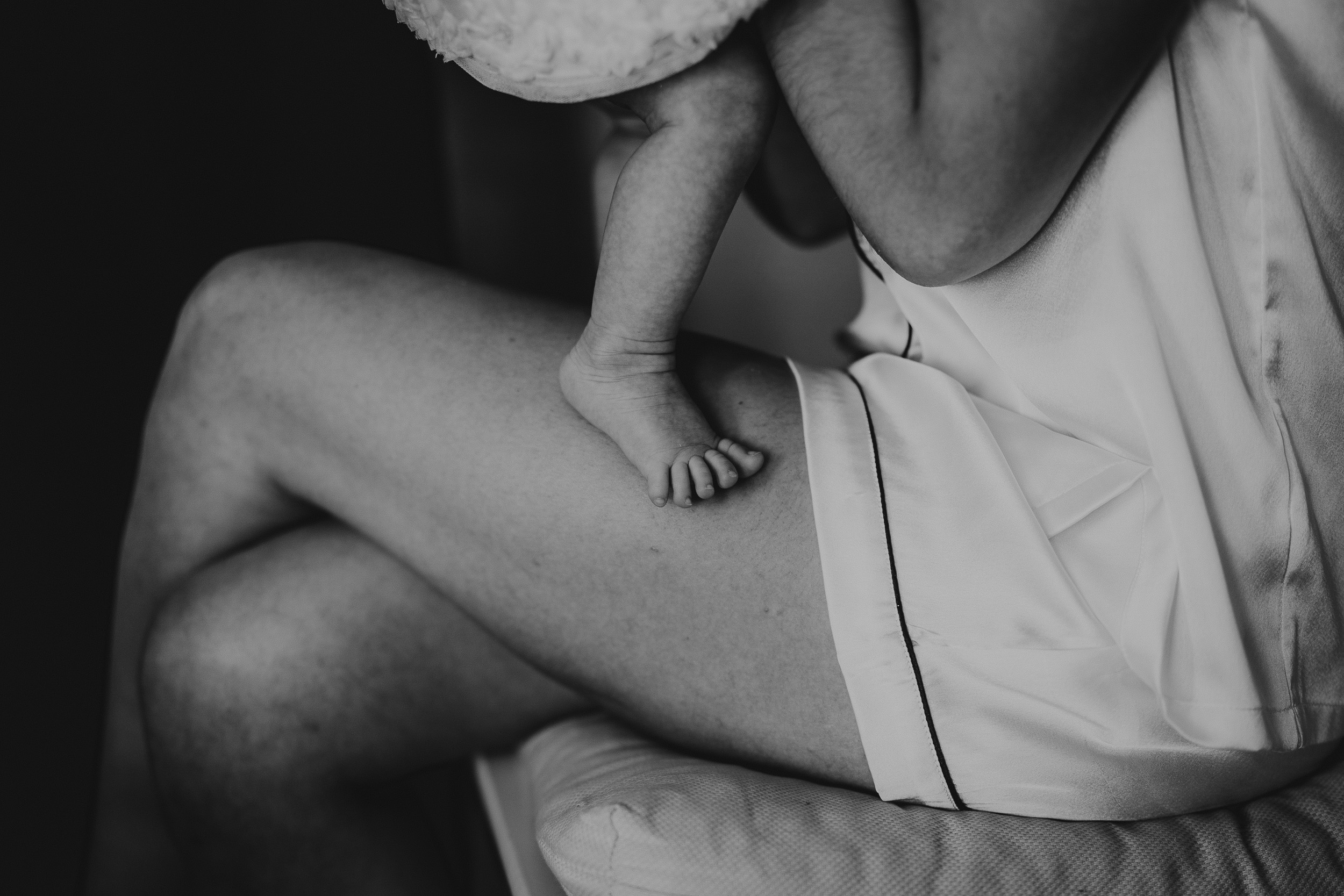 A black and white wedding photo depicting a woman holding a baby.