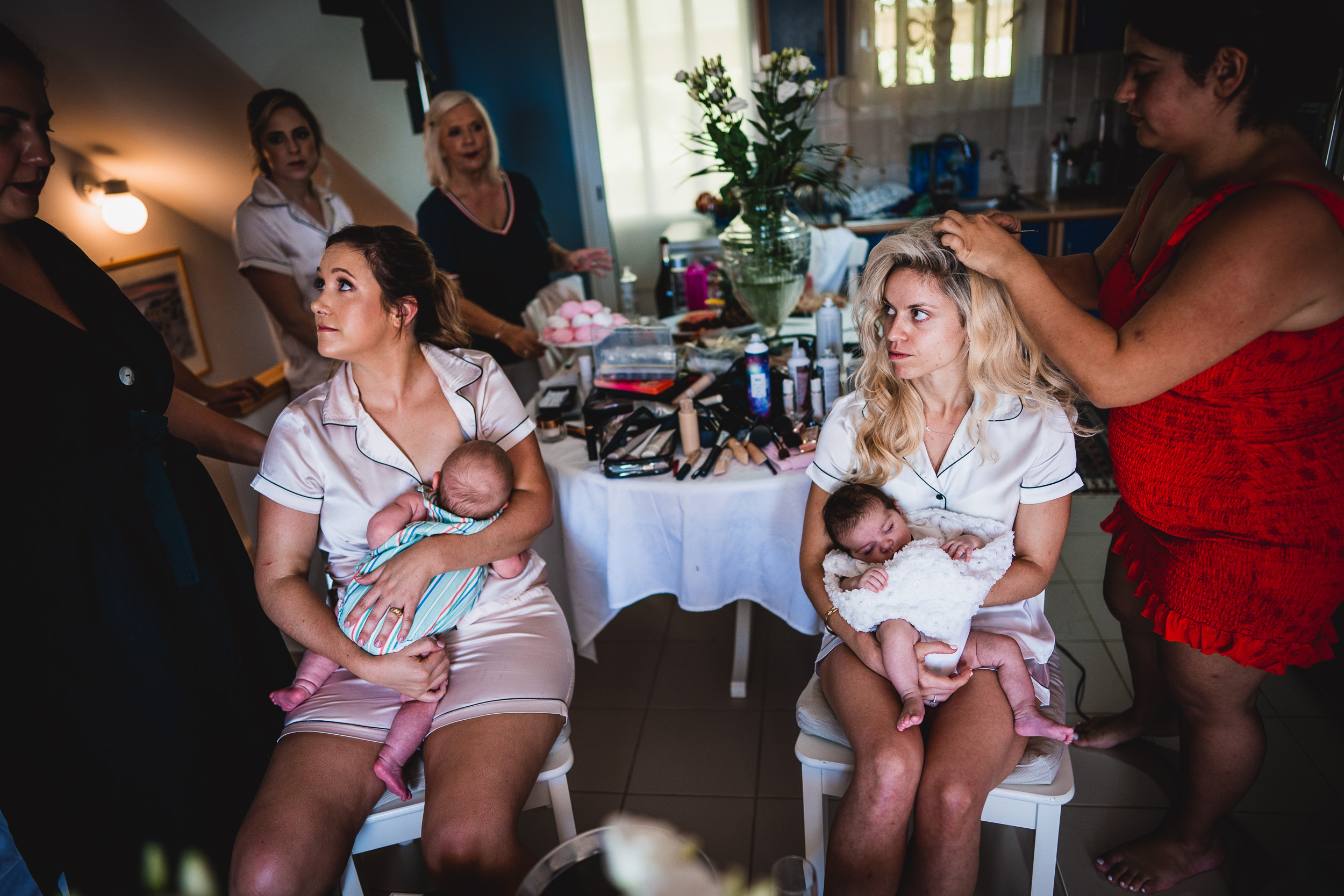 Bride and bridesmaids getting ready for a wedding, captured by a wedding photographer.