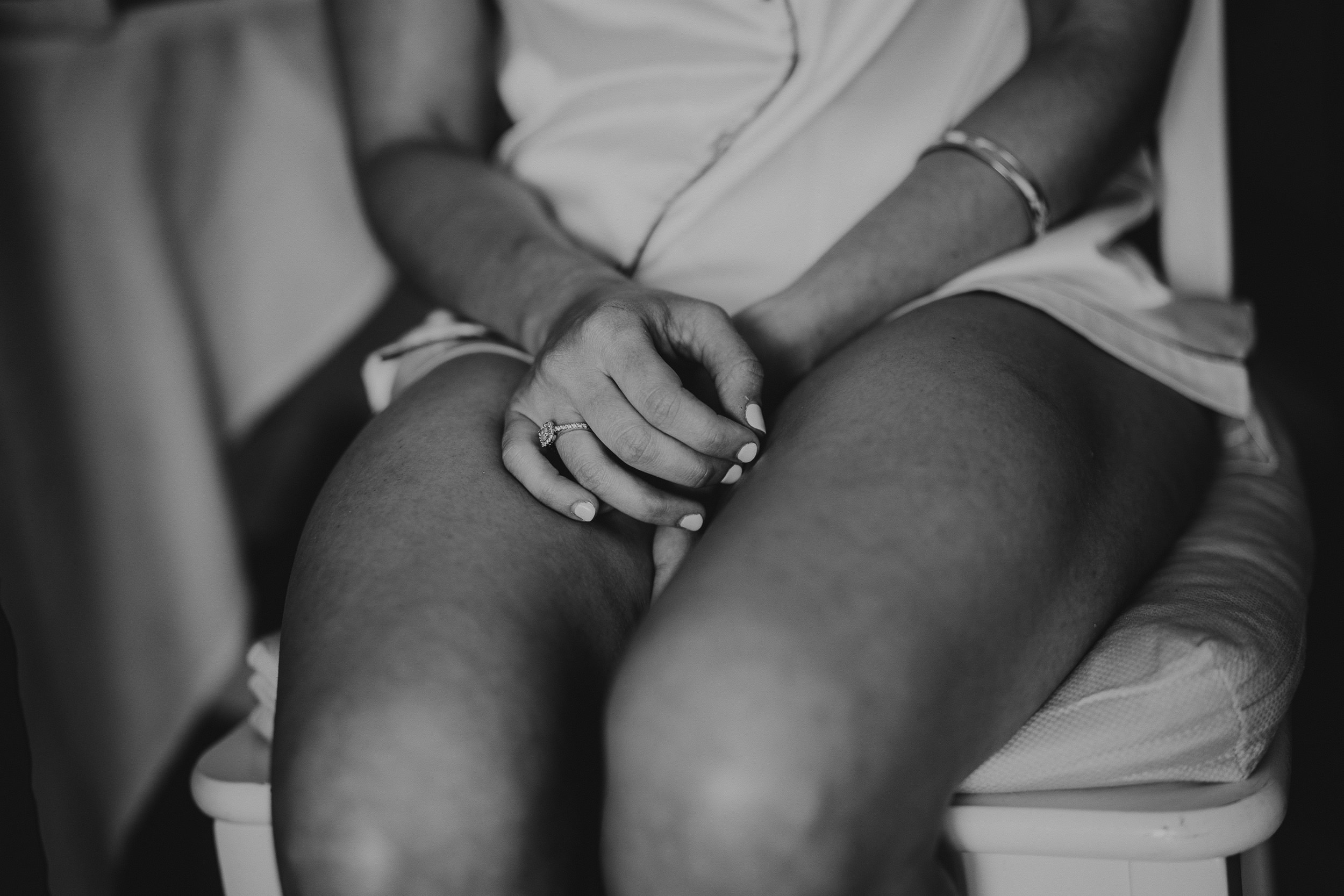 A wedding photo of a woman sitting on a chair.