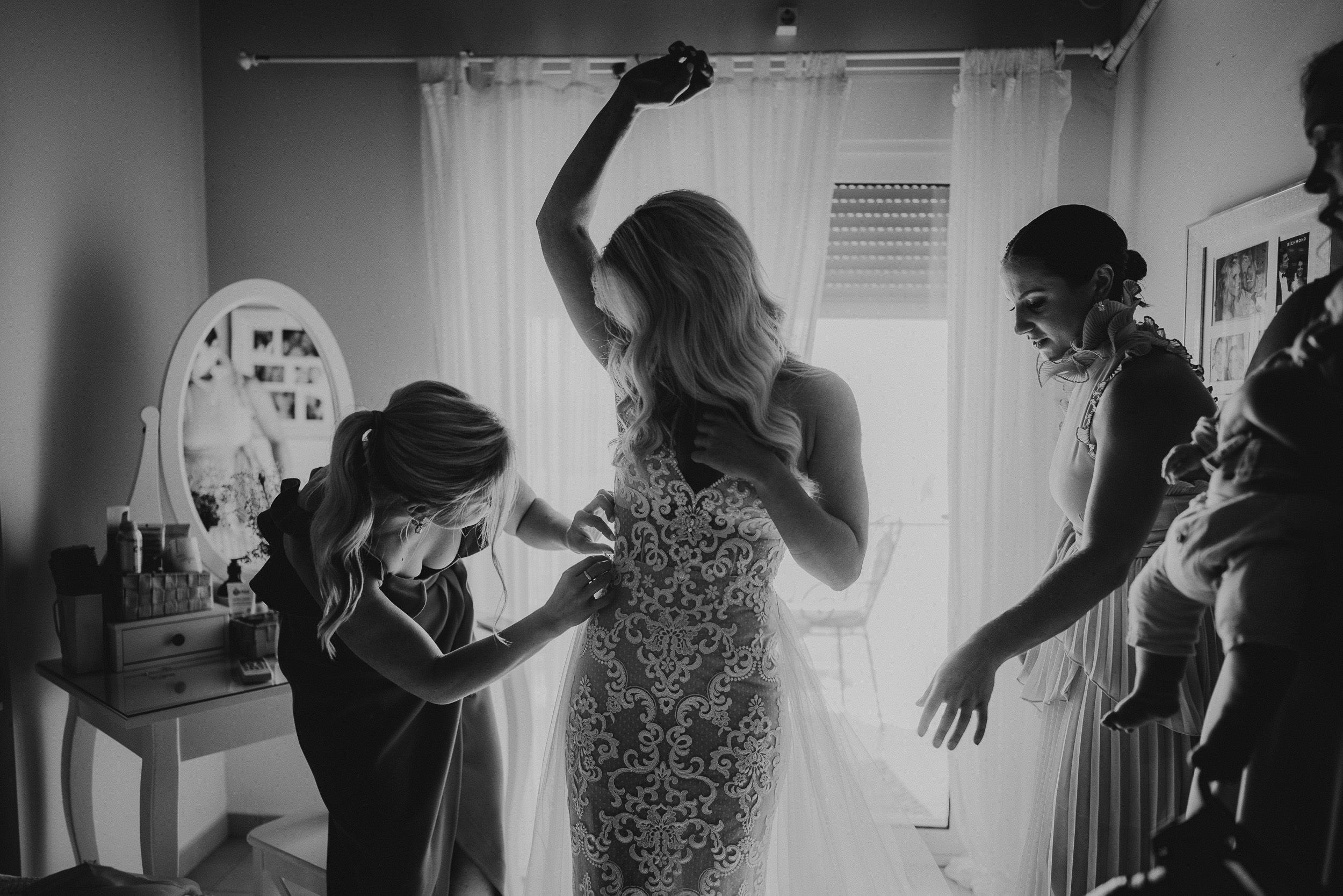 A bride getting ready for her wedding in Greece, joined by the groom.