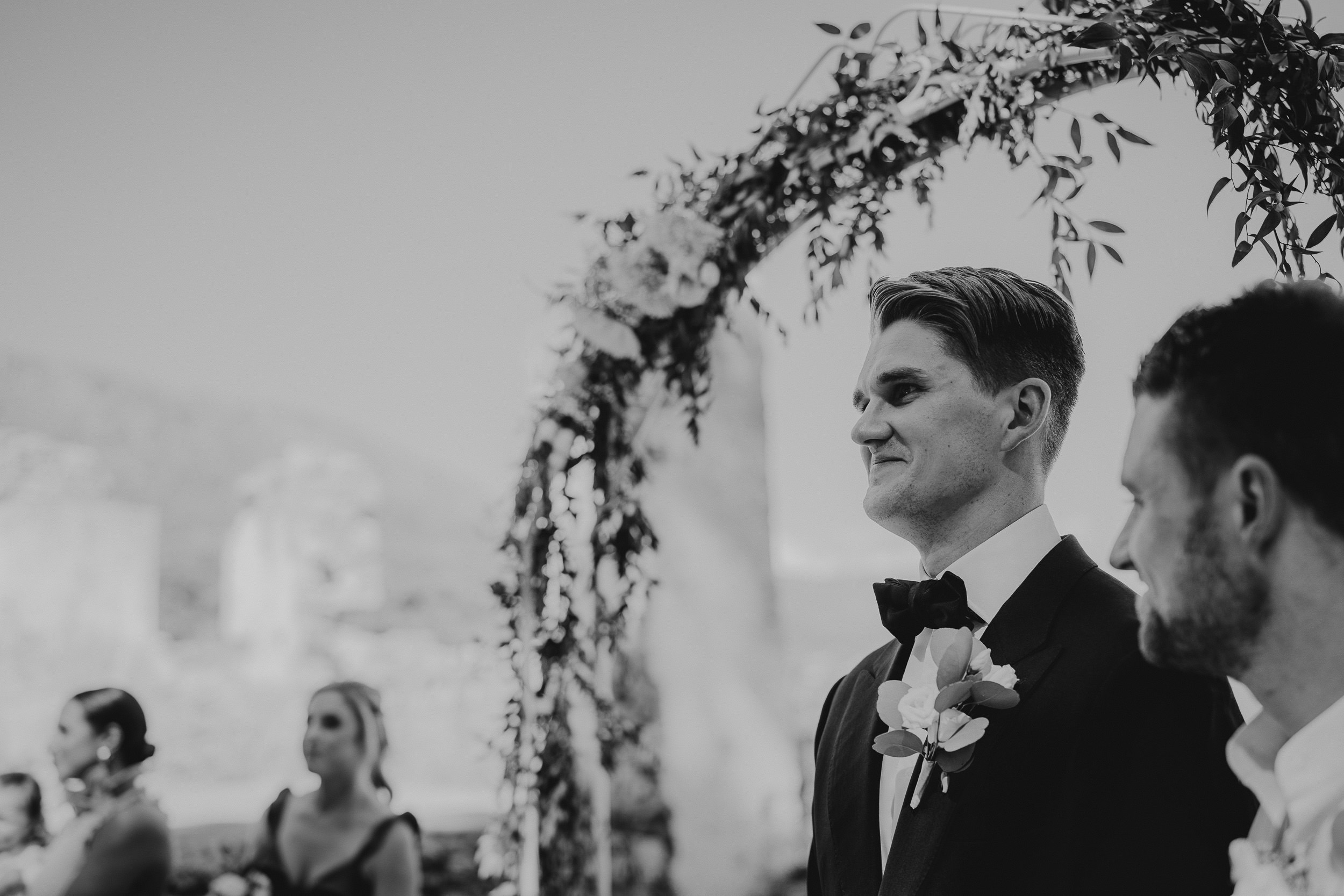 A bride and groom exchange heartfelt glances during their wedding ceremony.