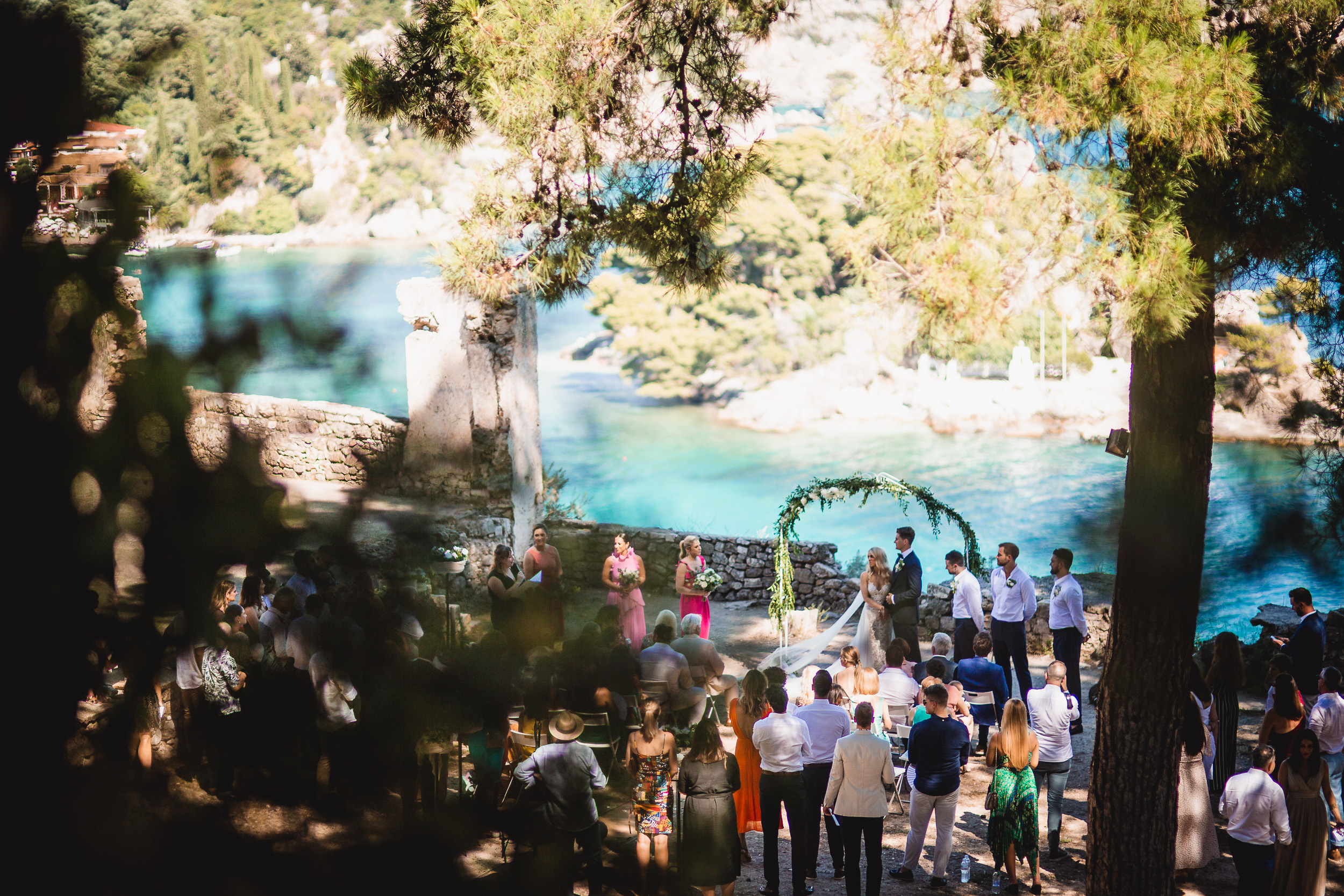 An outdoor wedding ceremony in Croatia with the groom and bride posing for wedding photos.