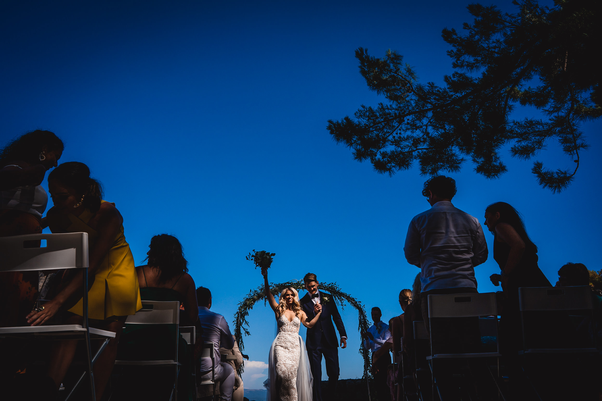 A wedding ceremony with the bride and groom under the blue sky.