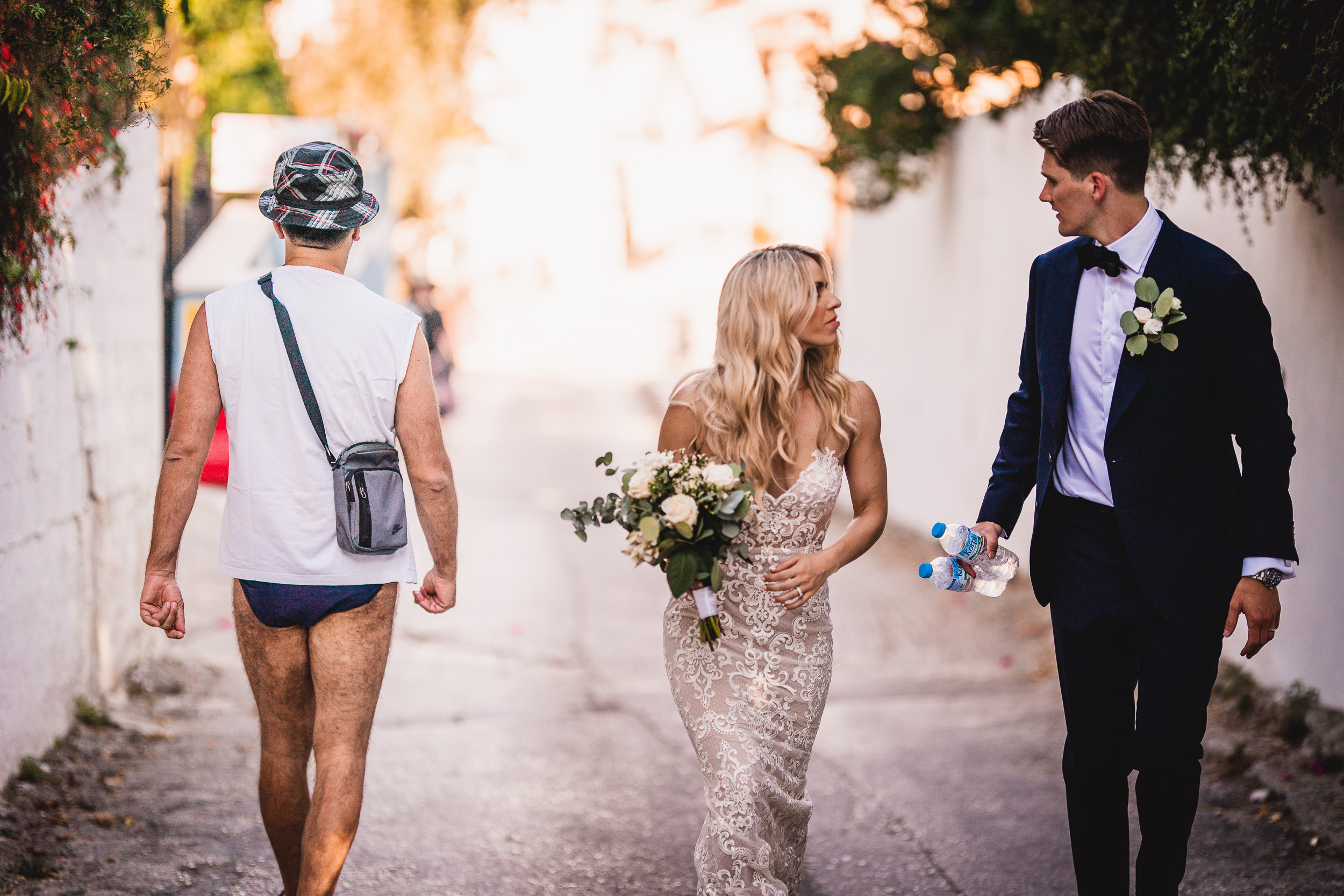 A bride and groom captured by their wedding photographer during a stroll.