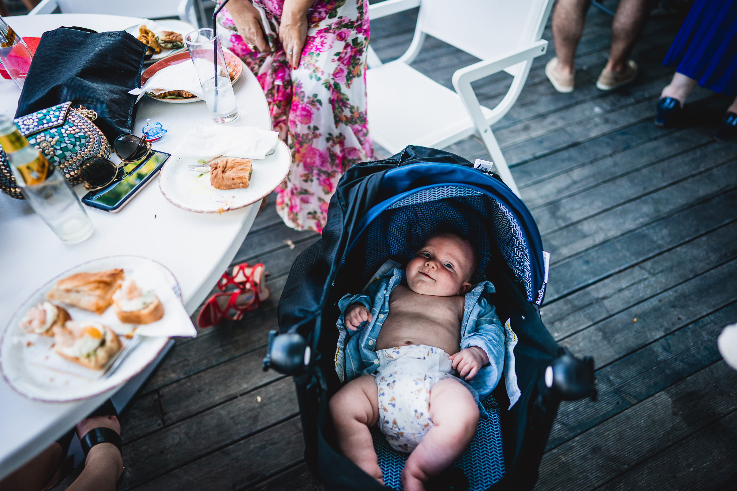 A bride's baby in a stroller captured by the wedding photographer.