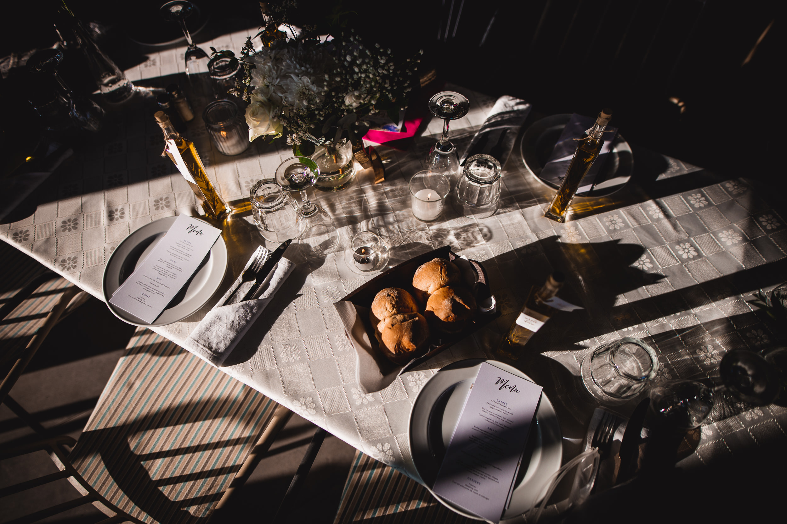 A table is set for a wedding dinner party.