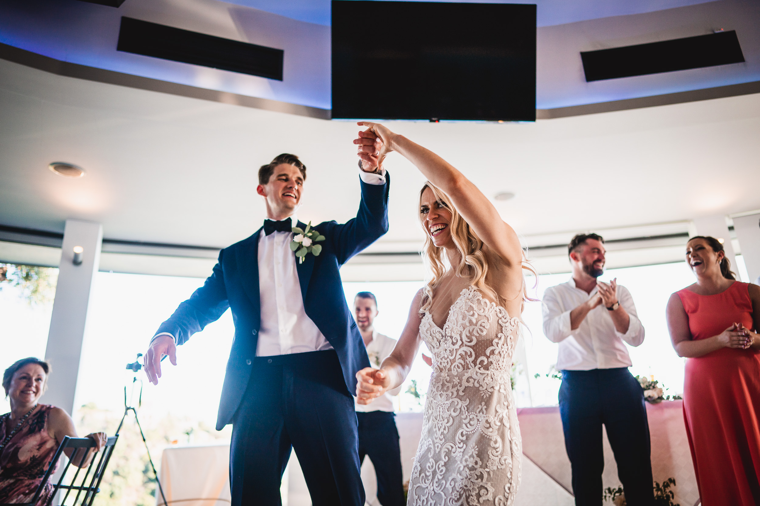 A bride and groom dancing at their wedding reception, captured by a wedding photographer.