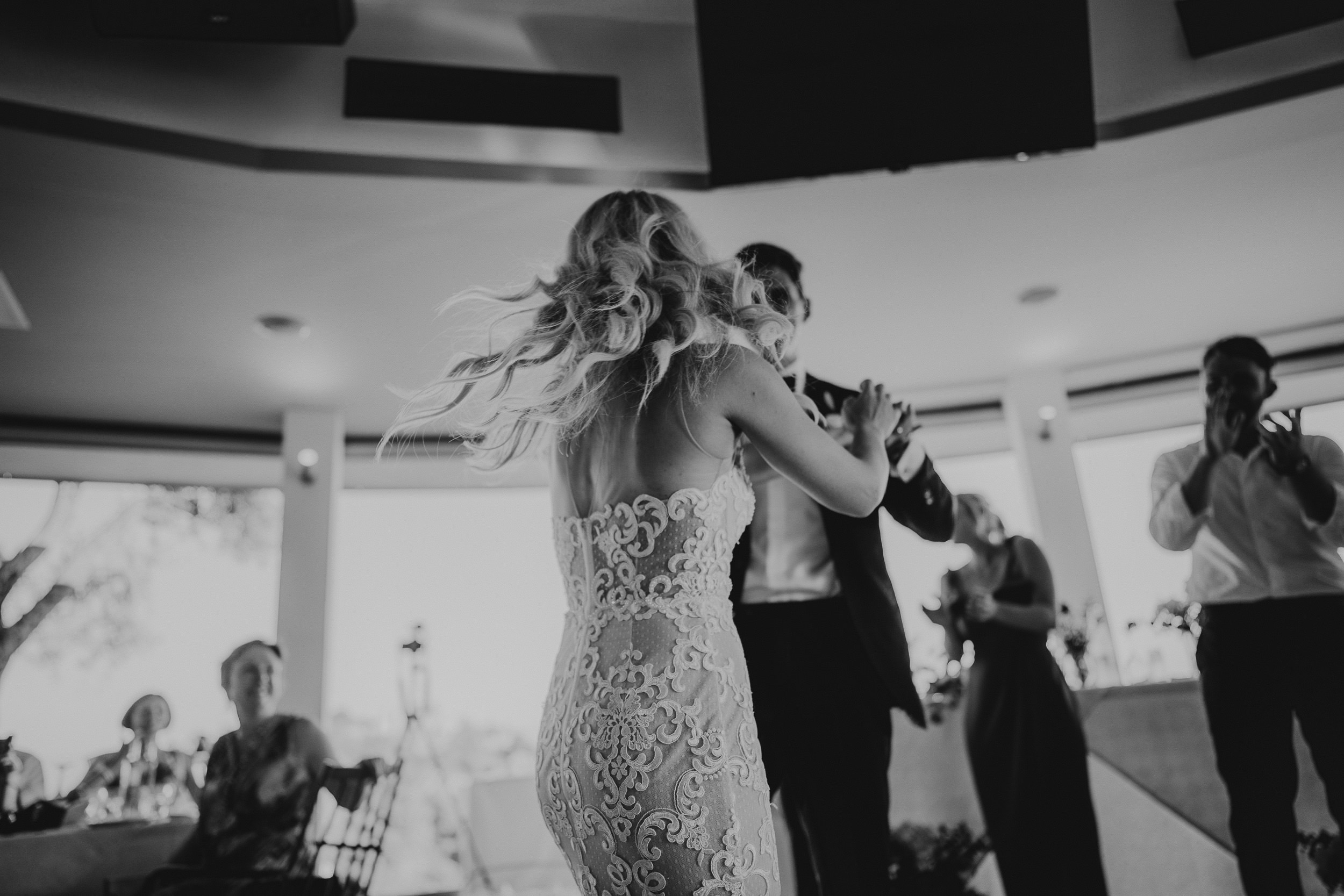 A bride and groom captured by their wedding photographer as they dance at their wedding reception