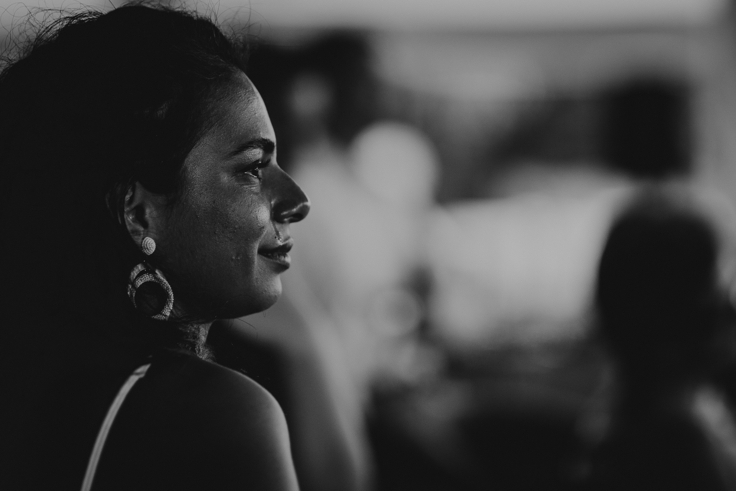 A bride posing for a black and white wedding photo.