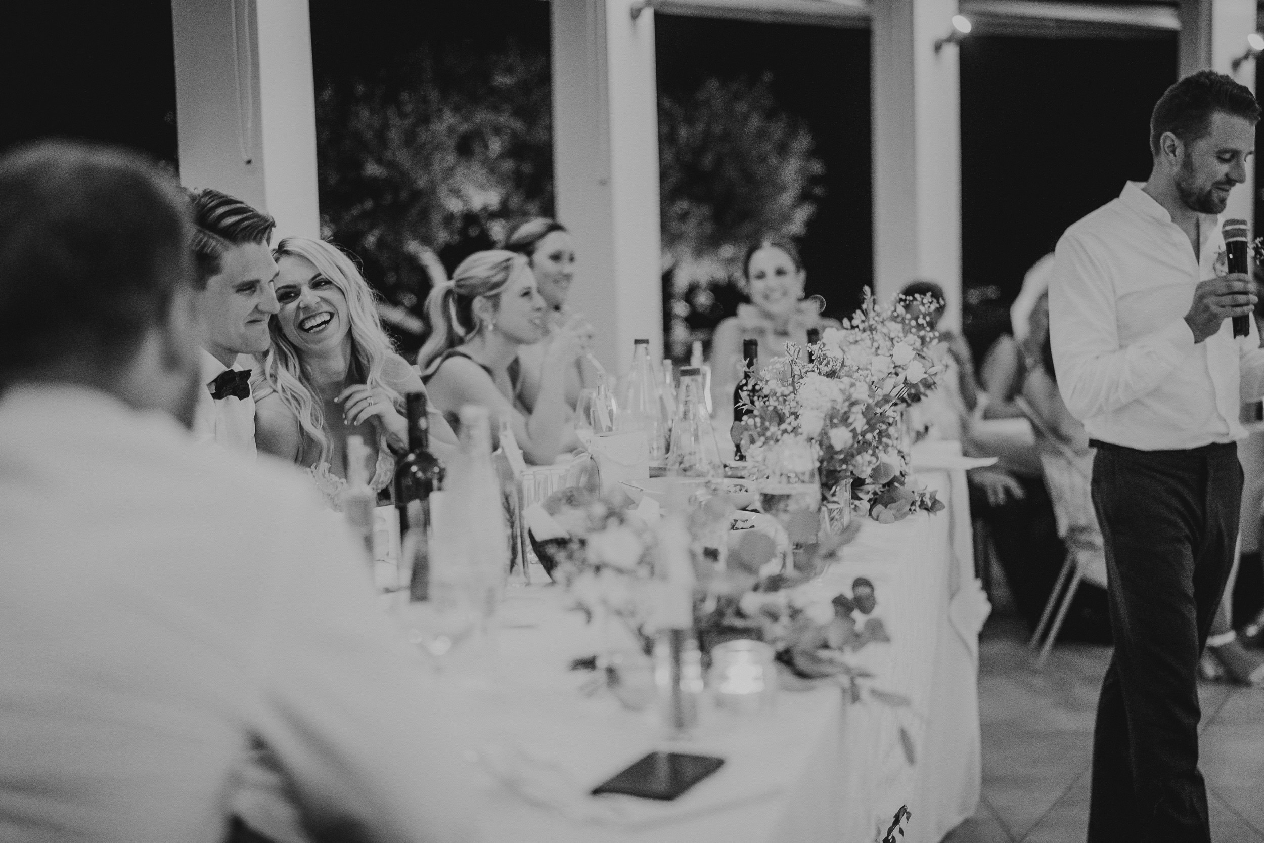 A groom giving a speech at the wedding reception.